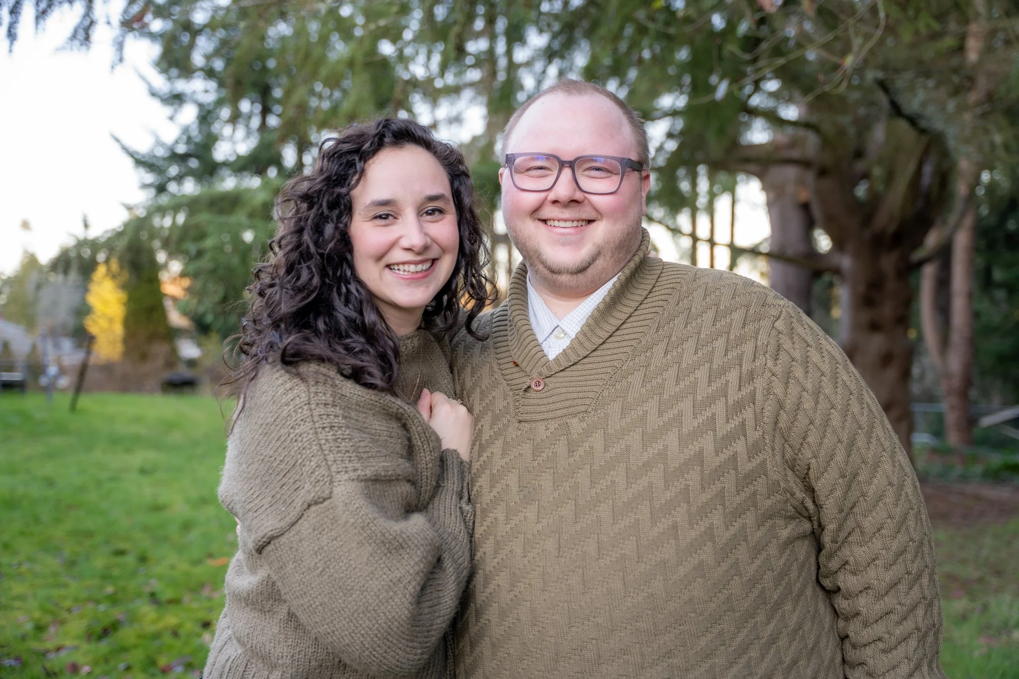 Dr.'s  Farrah and Ellis smiling big with trees in the background.ba