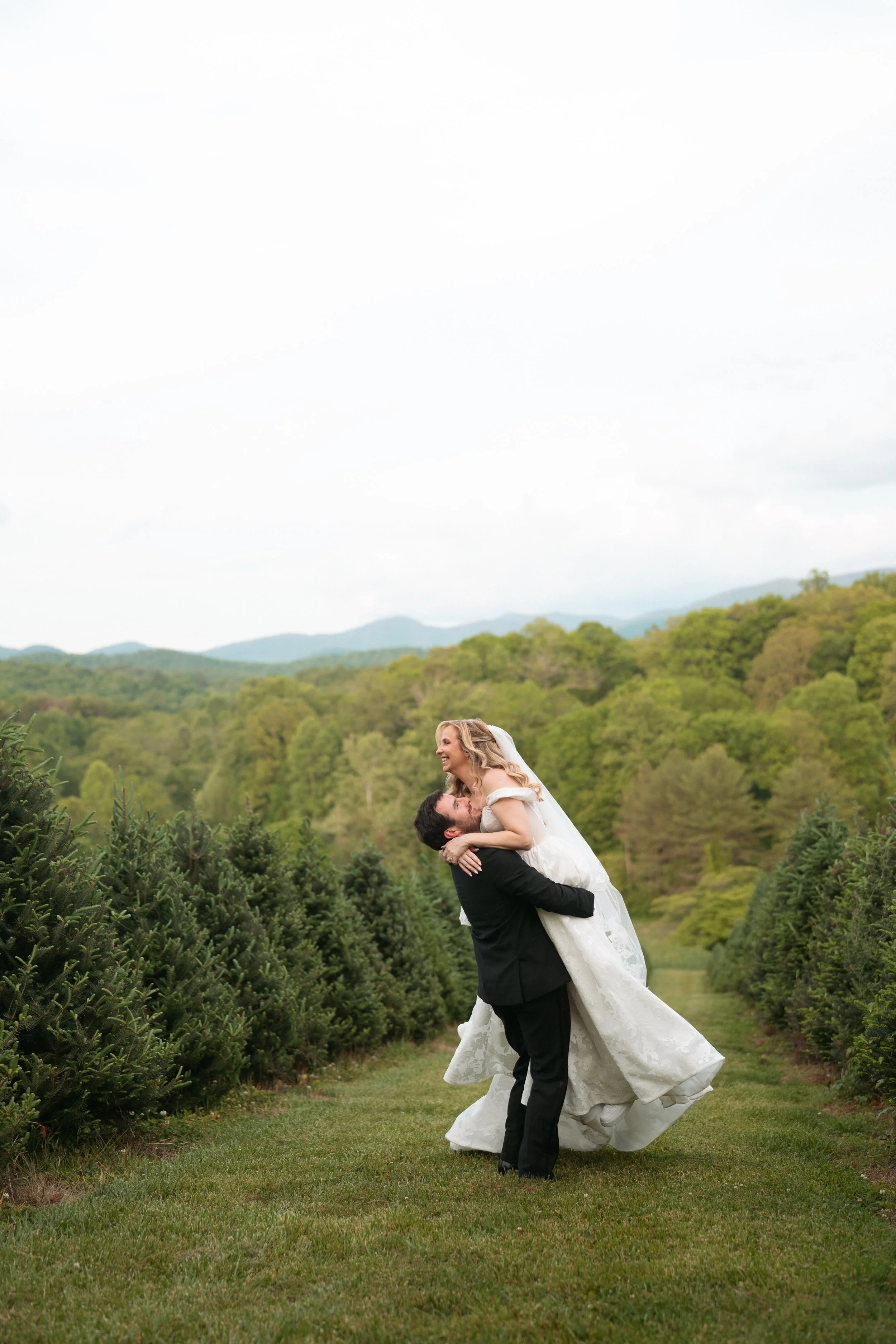 Bride and groom sharing a moment in a mountain forest, captured by a Georgia wedding photographer