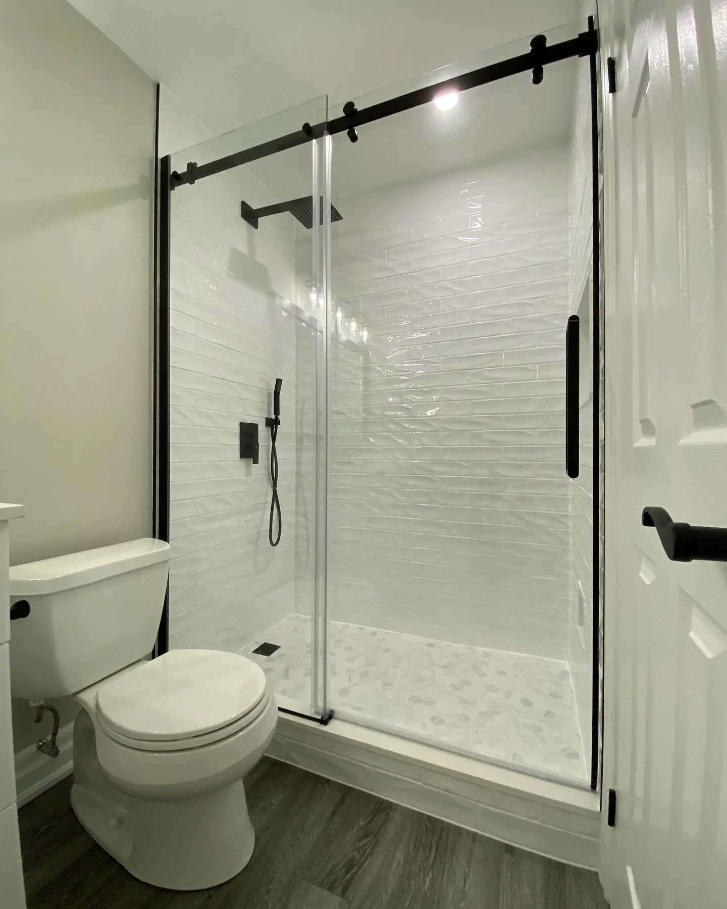 ✨ Bathroom Goals ✨
Check out this stunning transformation we just wrapped up!
From the custom vanity with matte black fixtures to the sleek sliding glass shower and textured subway tile, every detail was designed for function and style.

✔️ Frameless