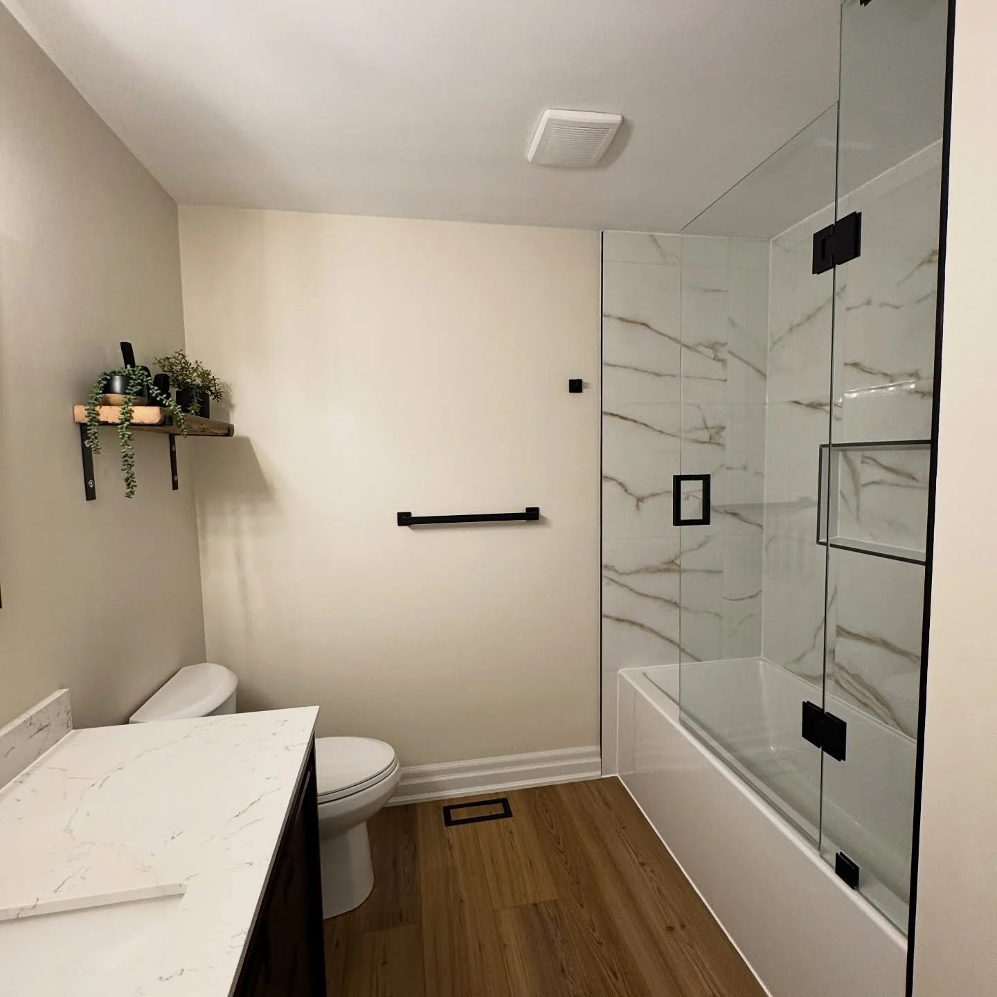 Fresh + Modern Bathroom Transformation ✨
From outdated to elevated &mdash; this sleek bathroom now features:
✔️ Elegant marble-look tiles with striking veining
✔️ Frameless glass shower doors with matte black hardware
✔️ Warm wood-look flooring for a