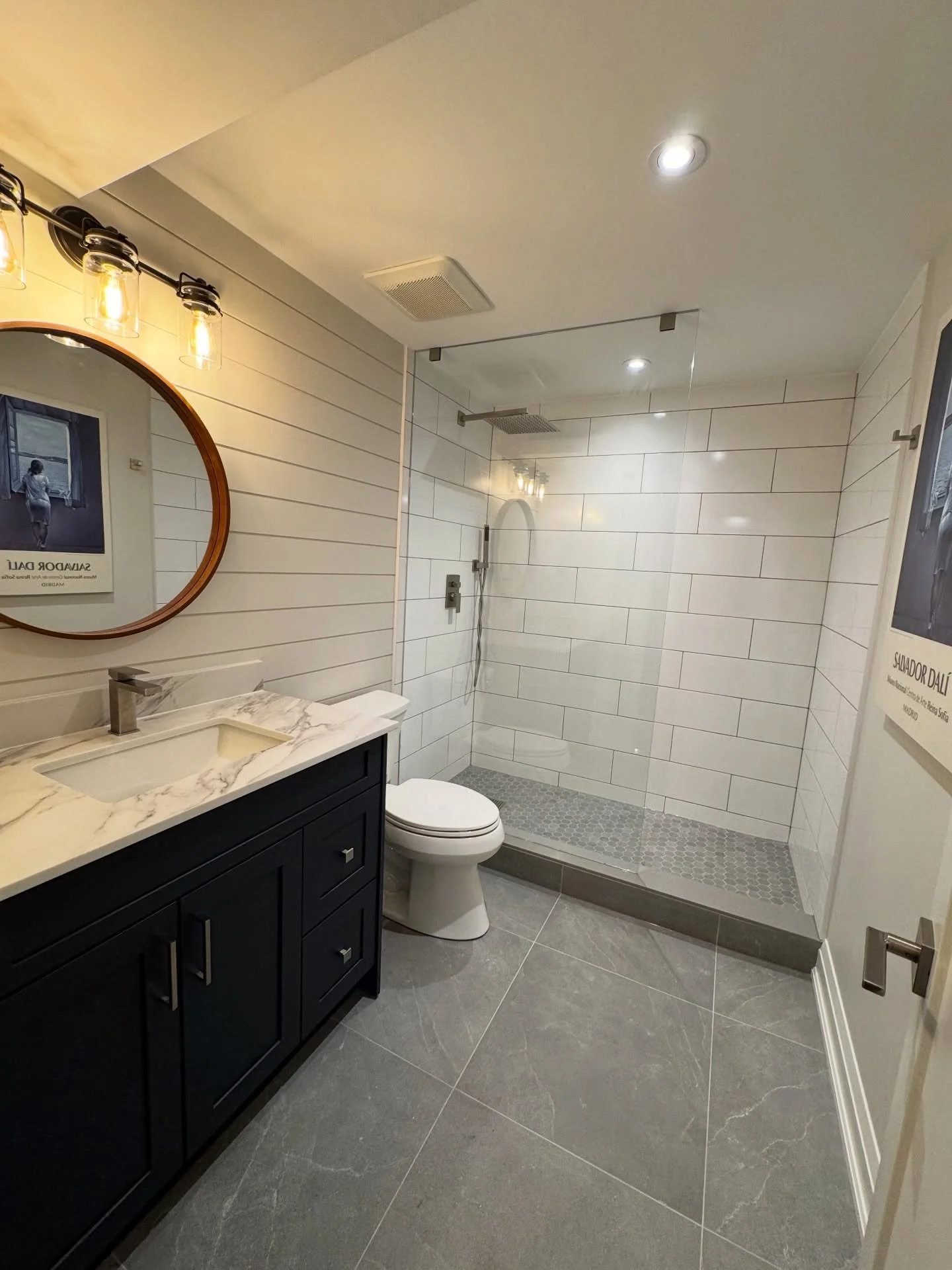 Basement Bathroom Before ➡️ After 🔥
What was once an outdated basement space is now a bright, modern, spa-style bathroom.

✔️ Custom tiled walk-in shower
✔️ Statement shiplap feature wall
✔️ Large-format tile flooring
✔️ Modern vanity &amp; upgraded