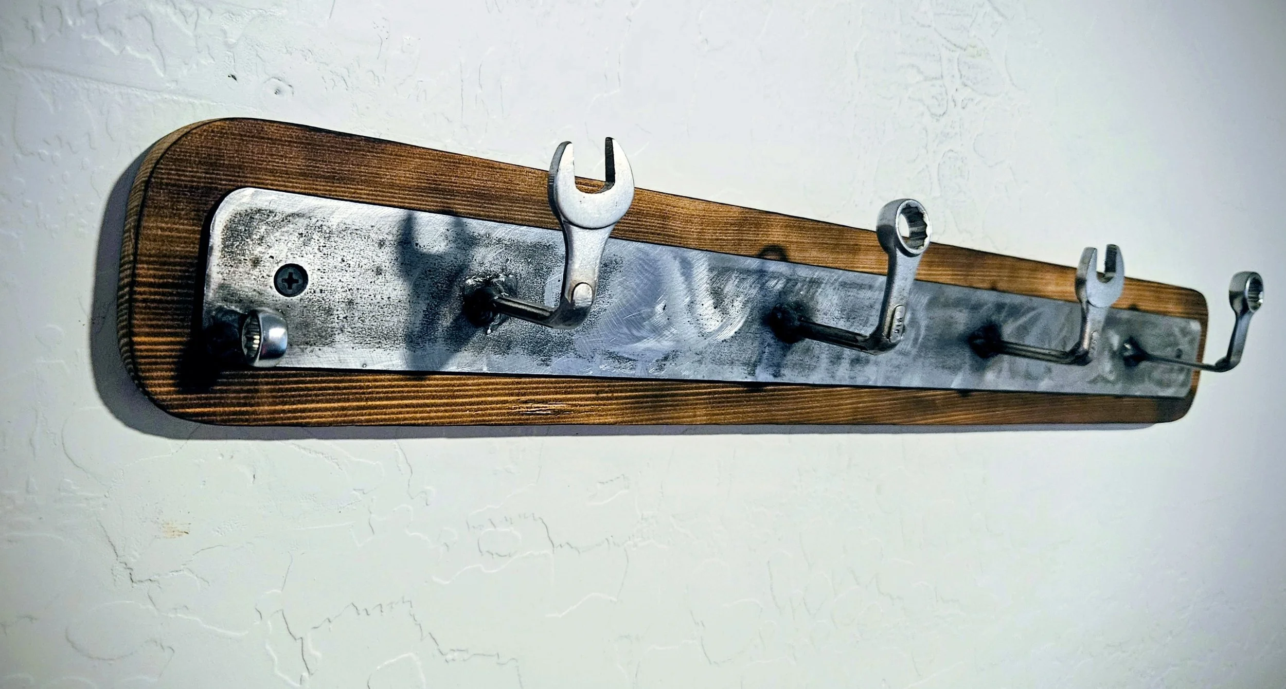 I welded up this cool little metal and wood rack for my welding hoods, I am also selling them on Etsy. Burned wood and everything clear coated. 