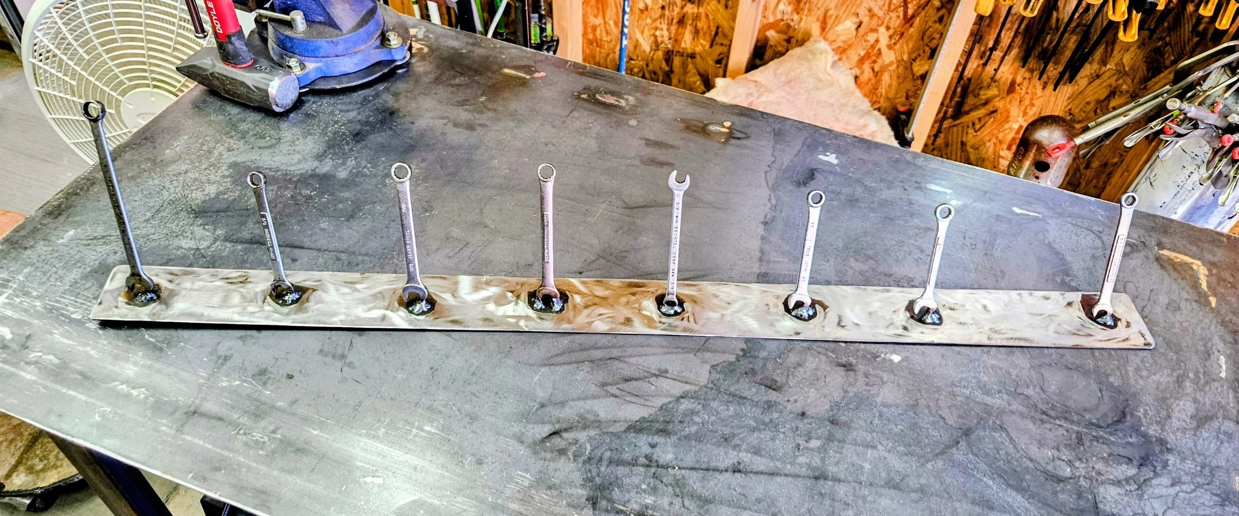 Grind Disk wall rack made with 2" flat bar and wrenches welded to hold 4.5" Grinder
 Disks