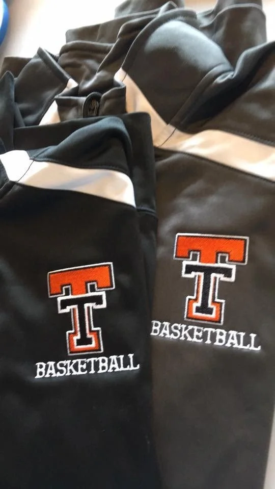Close-up of black jackets with embroidered Texas Tech University