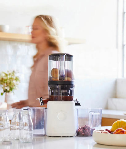 Home juicing setup with Nama J2 and fresh ingredients on a kitchen counter.