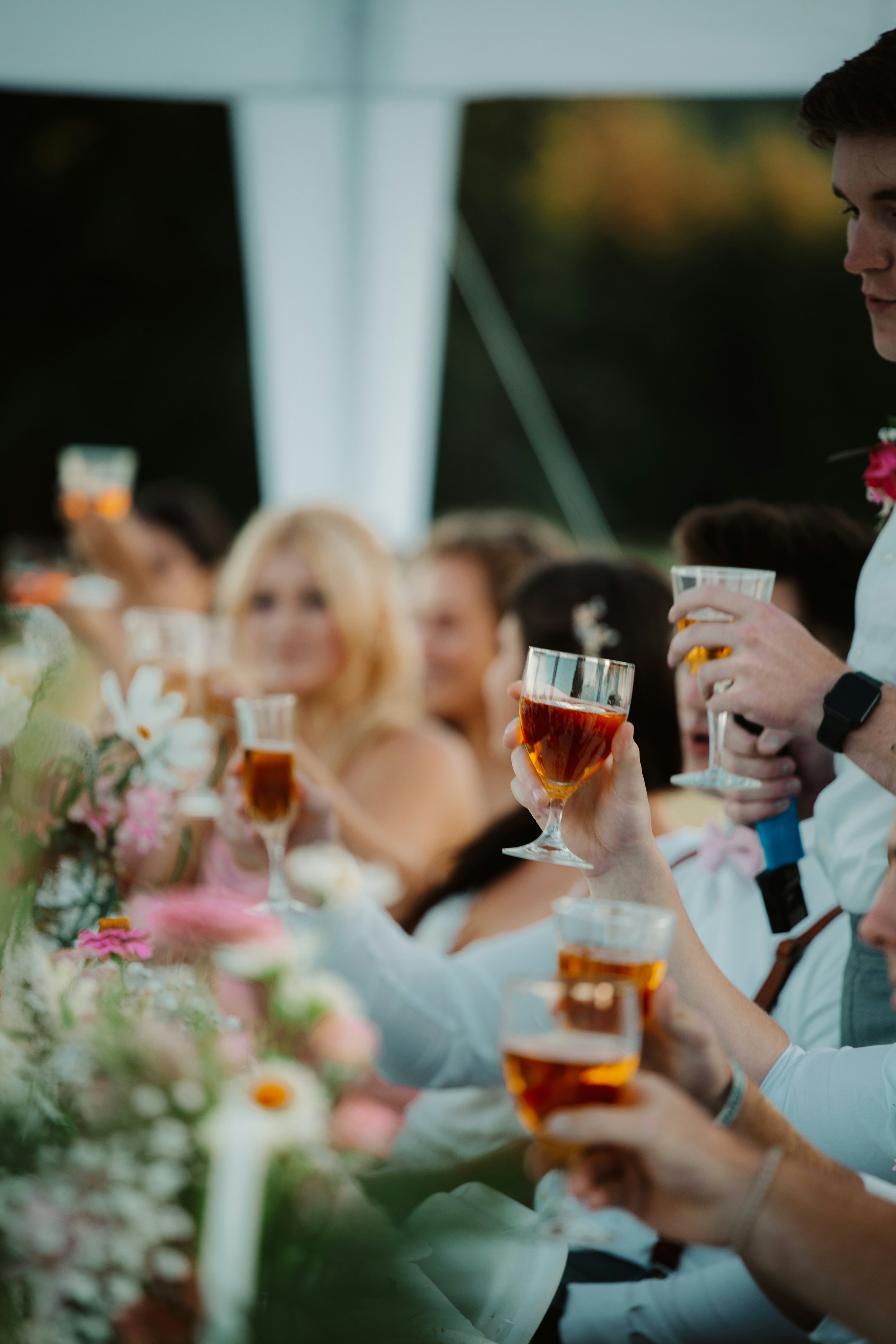 wedding guests sitting around a table with drinks