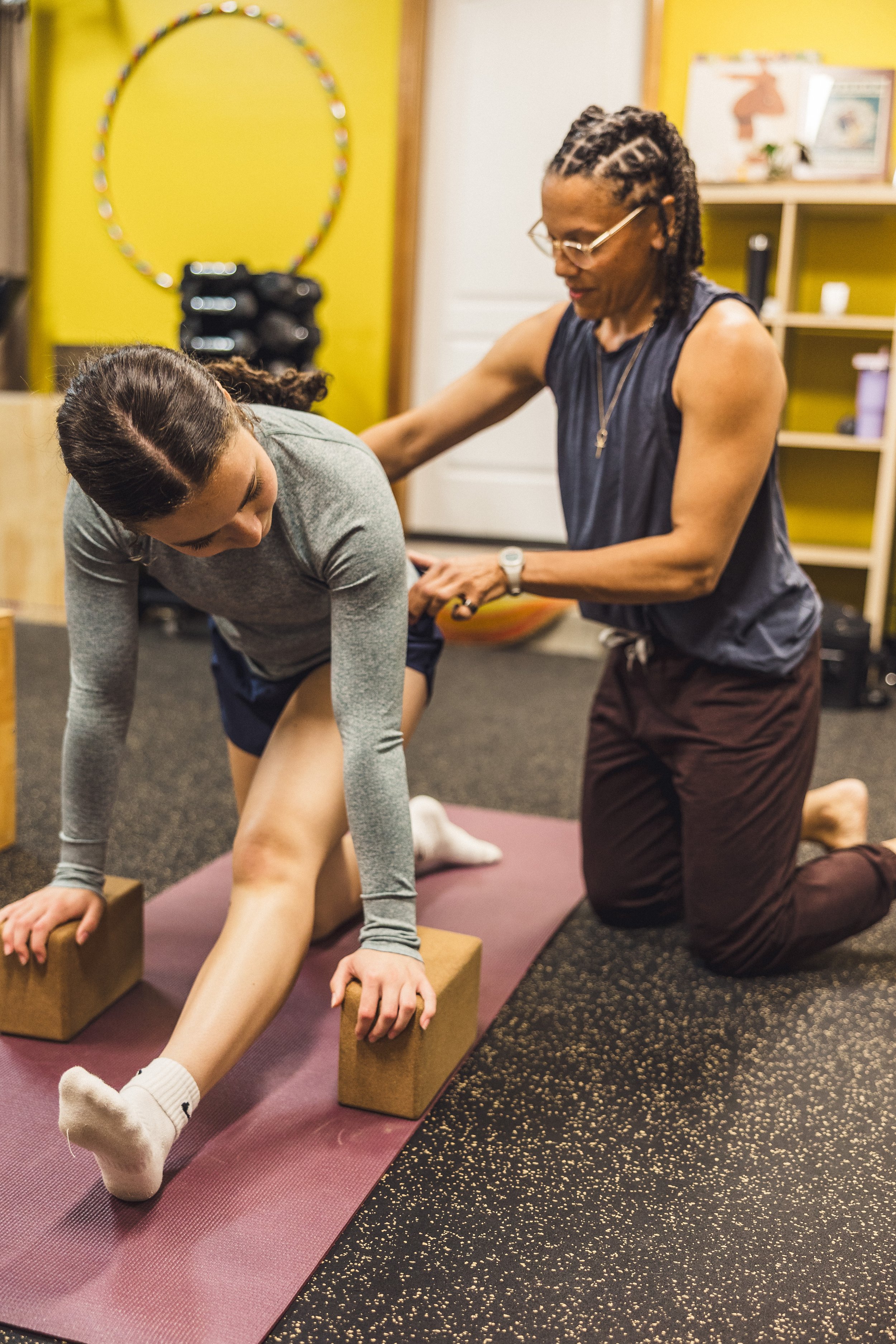 Shirley Brown assisting a client during a stretch.