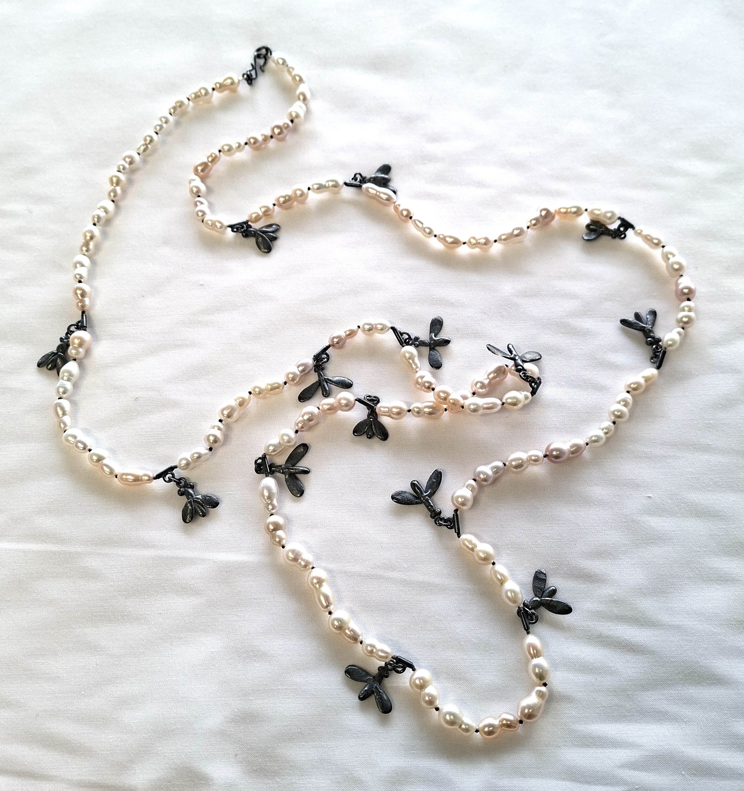 Ngarongaro, long strand of pearls.