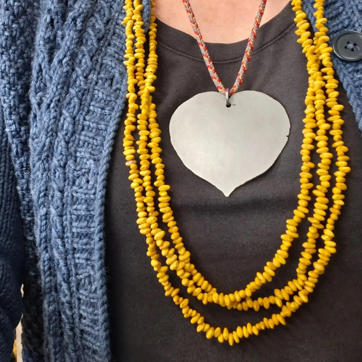 I've been meaning to make more of these kākano kōwhai necklaces for a while. 
The tag I make to join them has the region the seeds were collected in stamped on it. I considered using gps co-ordinates to mark the exact spot of the tree, but decided ag