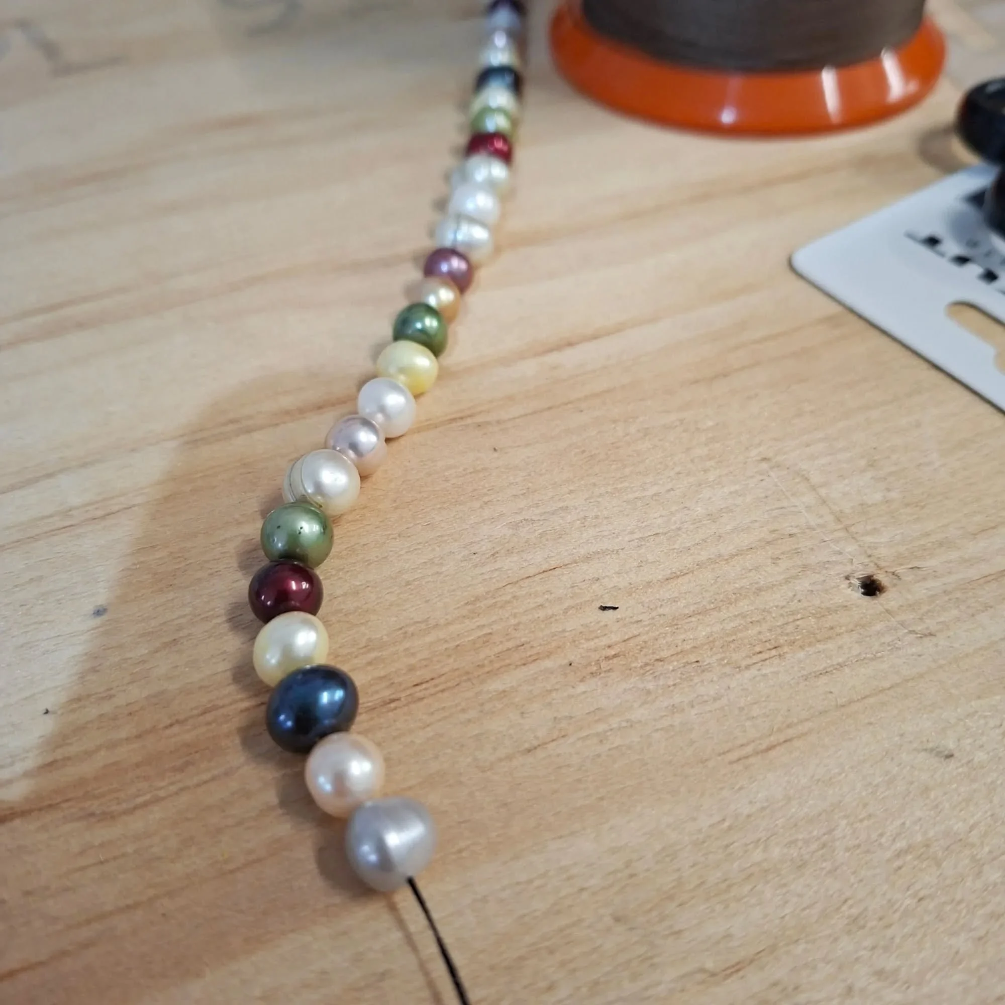 Little snake catch finds a purpose at the end of this long strand of outrageously multi-hued fresh water pearls. 

I'm working out how to knot firmly between pearls. I guess I could pay someone to do this for me, but at the moment I'm enjoying trying