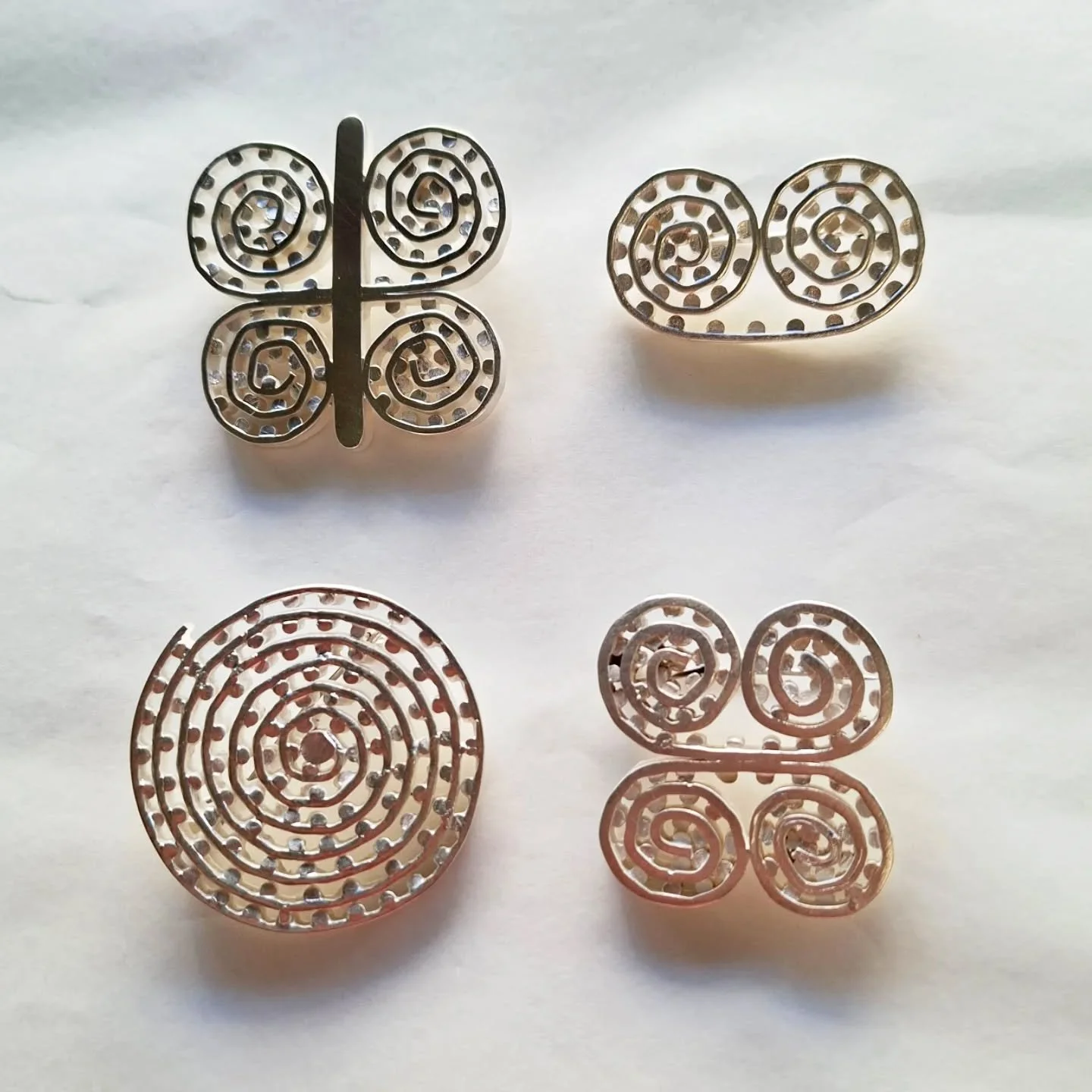 Pītau.
Sterling silver with stainless steel pin.
Hand fabricated from strips of sterling silver wire. 

These are a rethink of some brooches I made around 2016. They haven't changed much- I just wanted to make them again. 

These will be available at