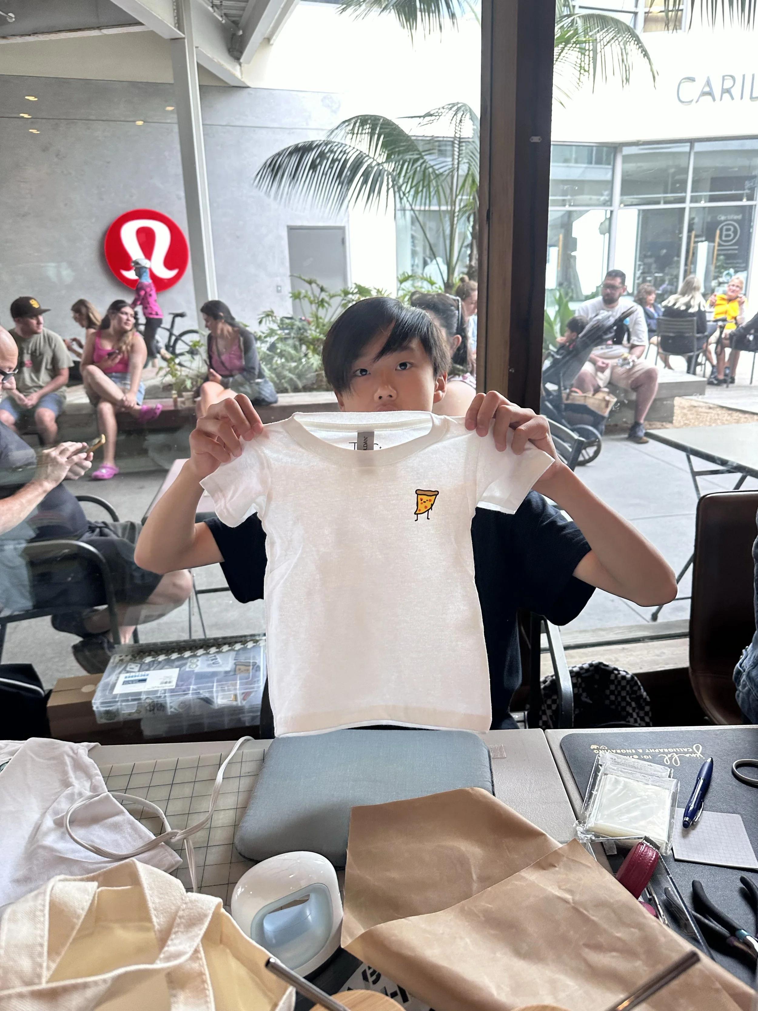 06-RealWorld-lululemon-popup-truman-holding-tshirt-age14.jpg