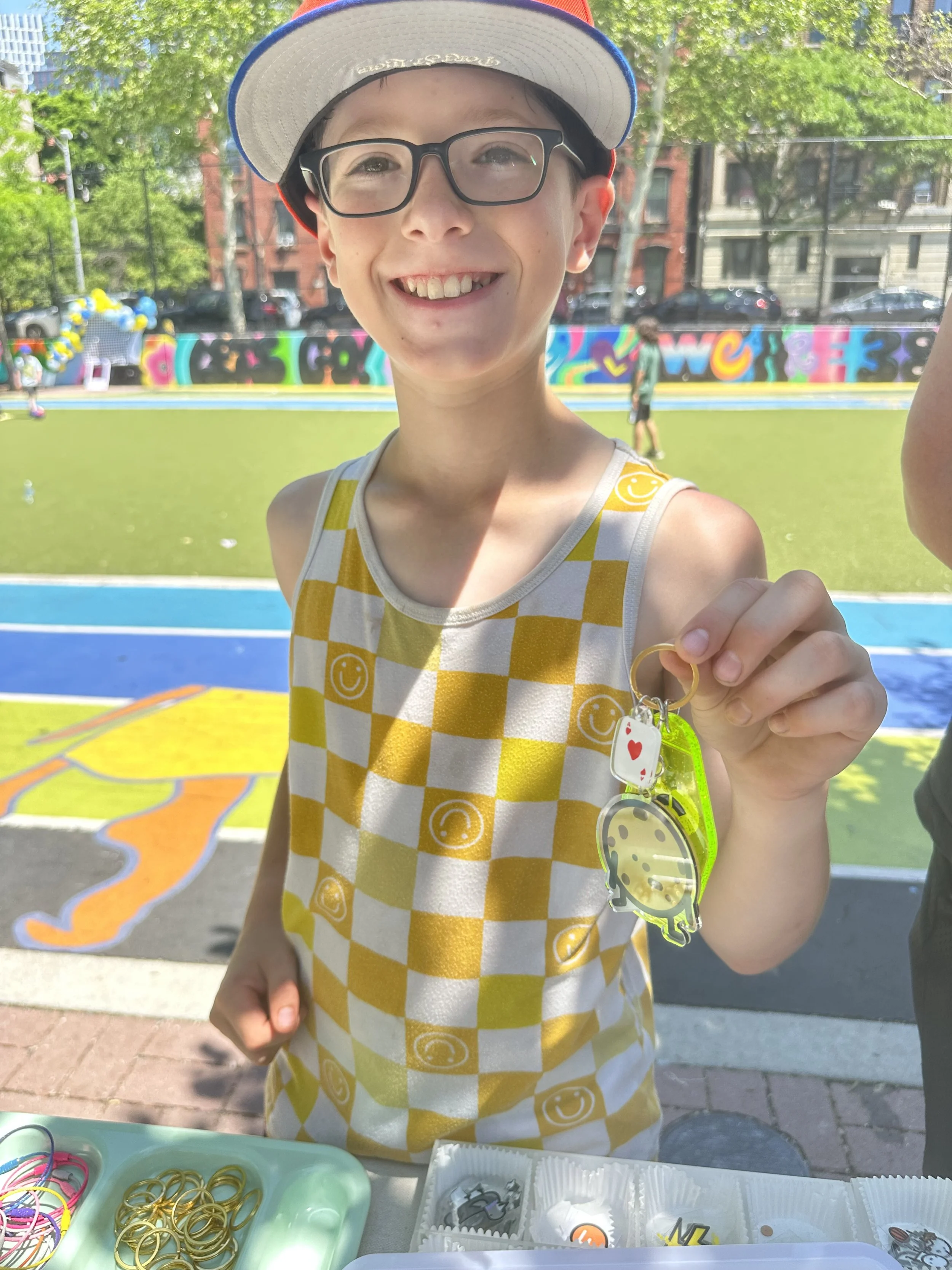 PS38-25-kid-yellow-checkered-top-holding-motel-keychain.jpeg