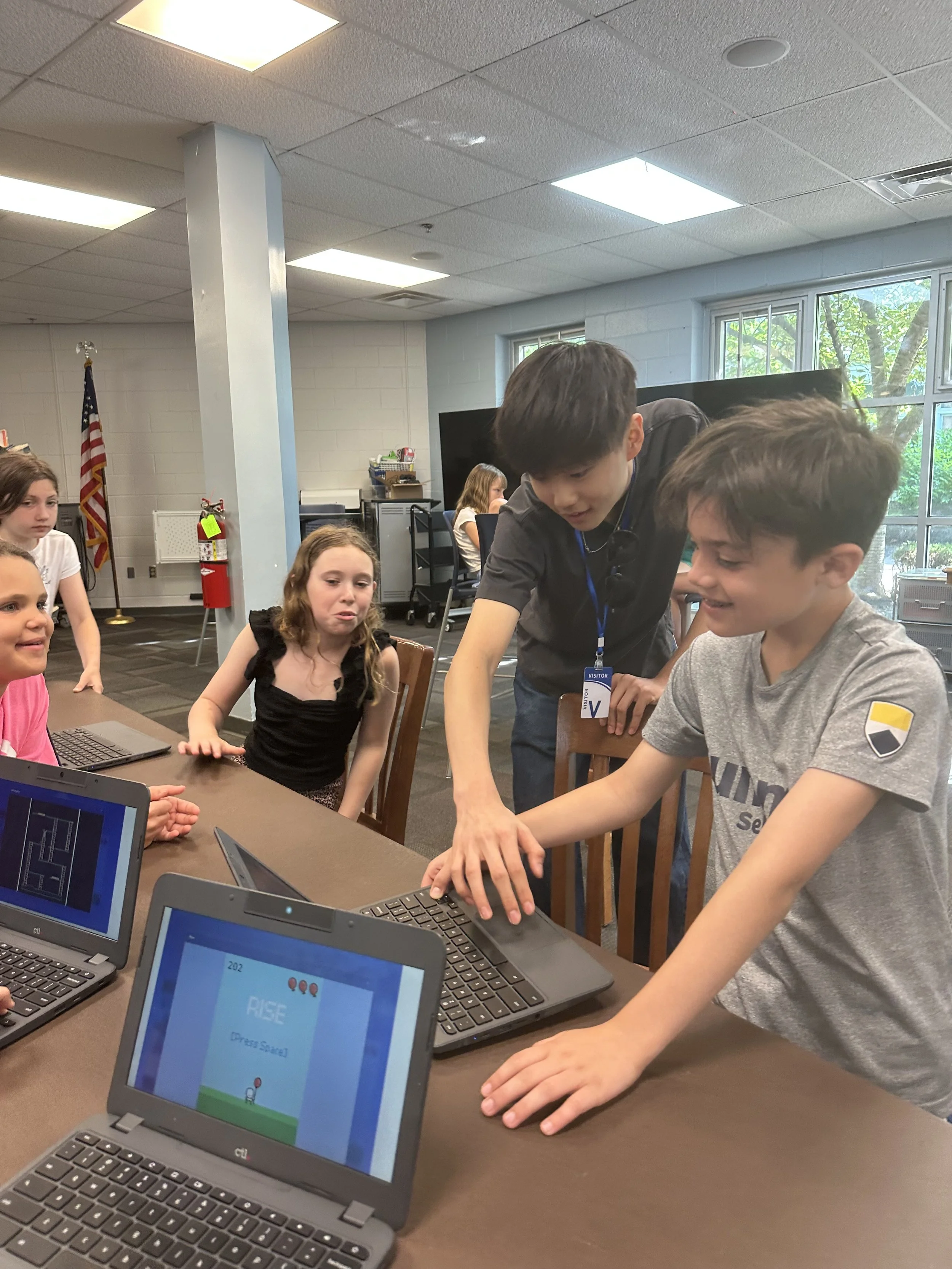 KNOLLWOOD-8-kids-around-laptop-rise-game-dup.jpeg