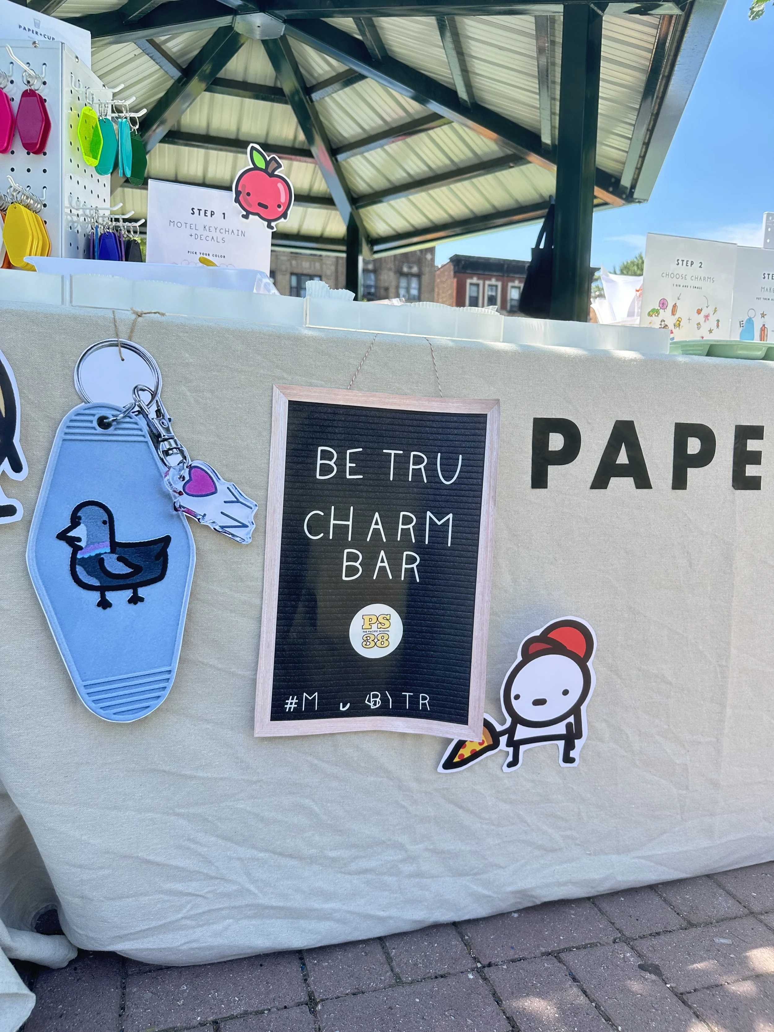 PS38-30-be-tru-charm-bar-sign-blue-keychain-on-table.jpeg