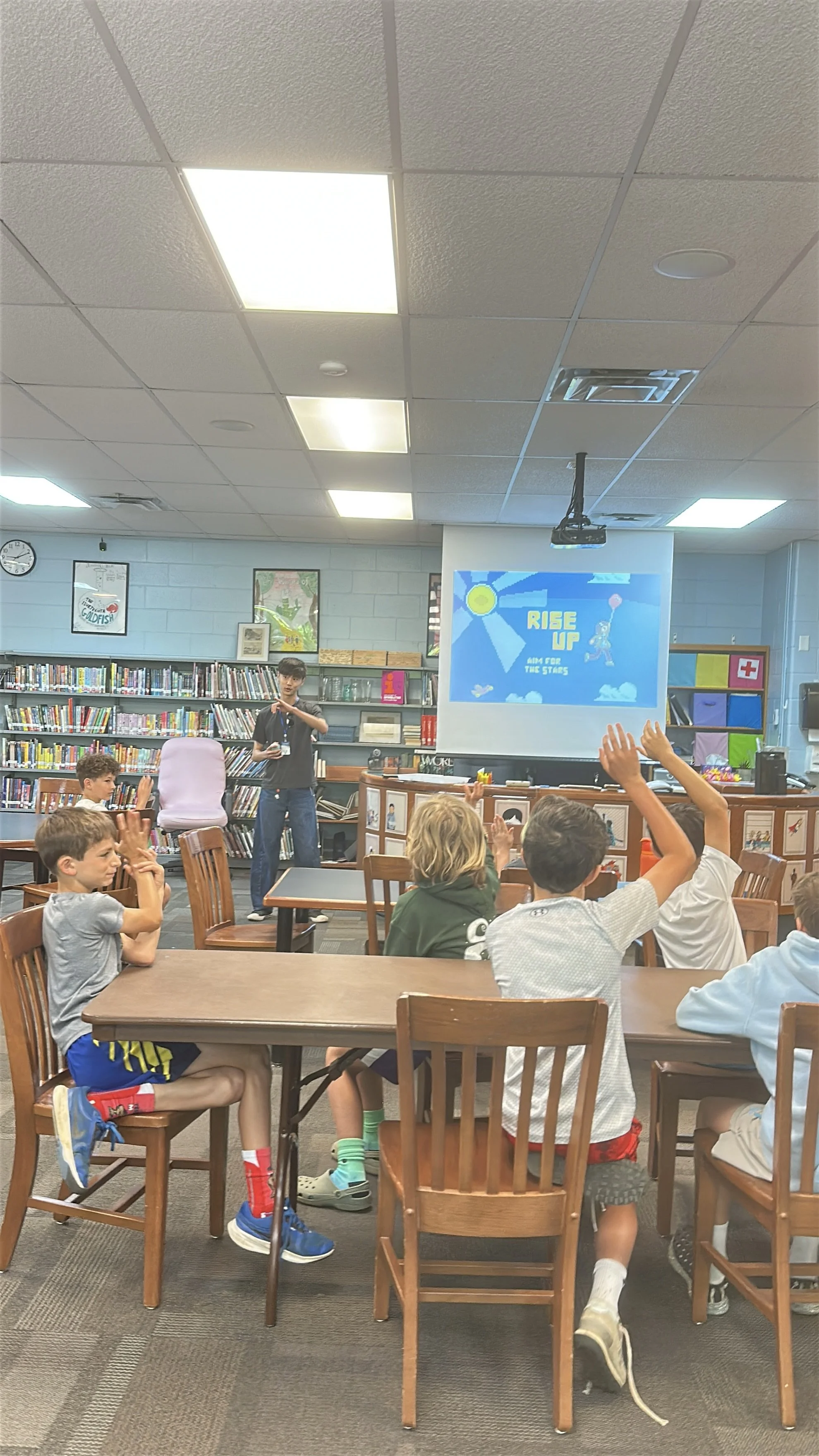 KNOLLWOOD-19-truman-presenting-rise-up-kids-raising-hands-2.jpg