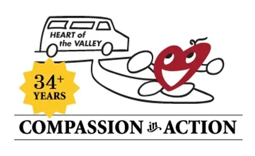 A cartoon heart character with a smiling face and arms in front of a car with the words 'Heart of the Valley.' A yellow badge indicates '34+ years,' and the text reads 'Compassion in Action.'