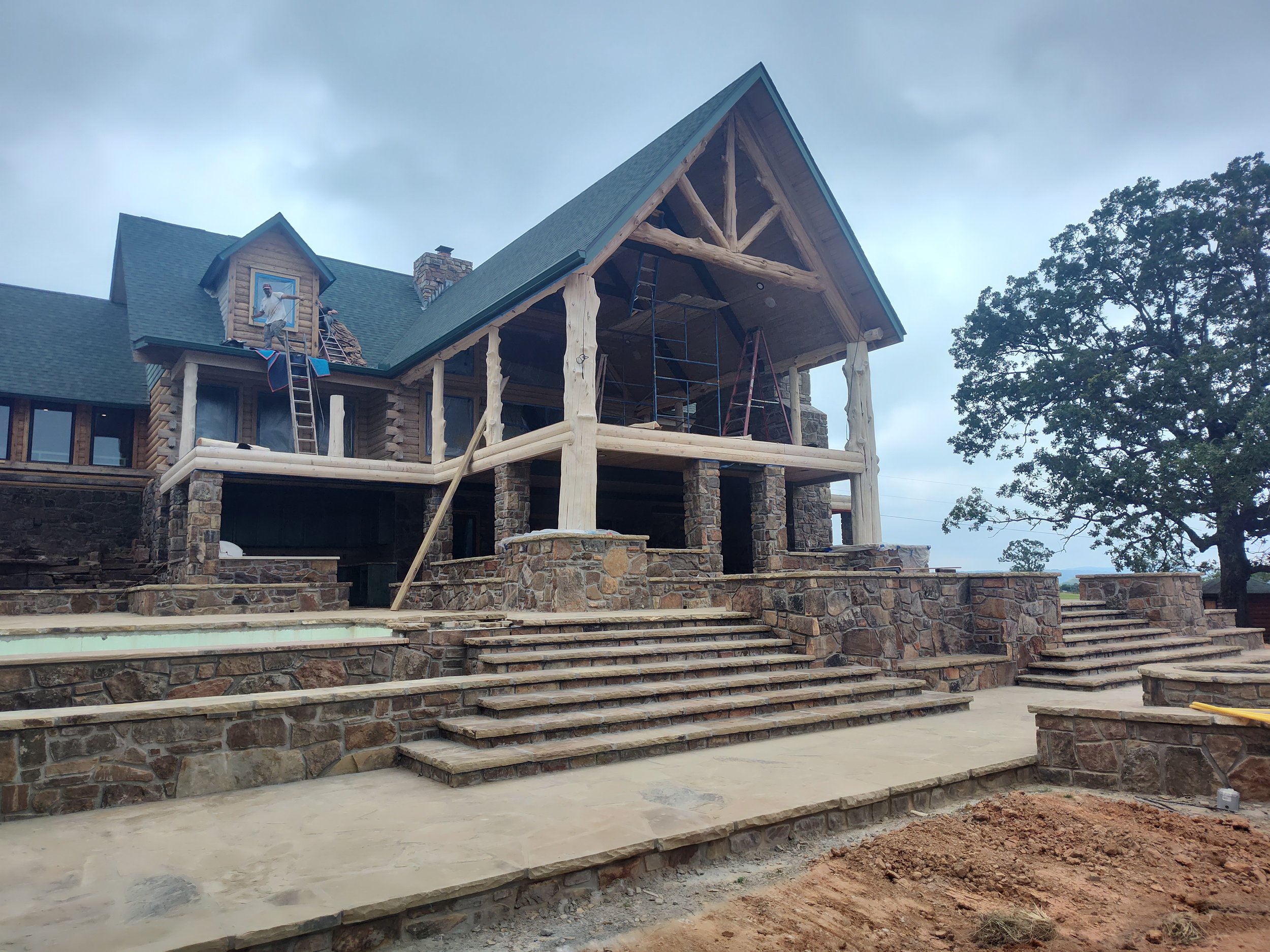 Exstension of back porch with rock work and cedar logs, ICF spa