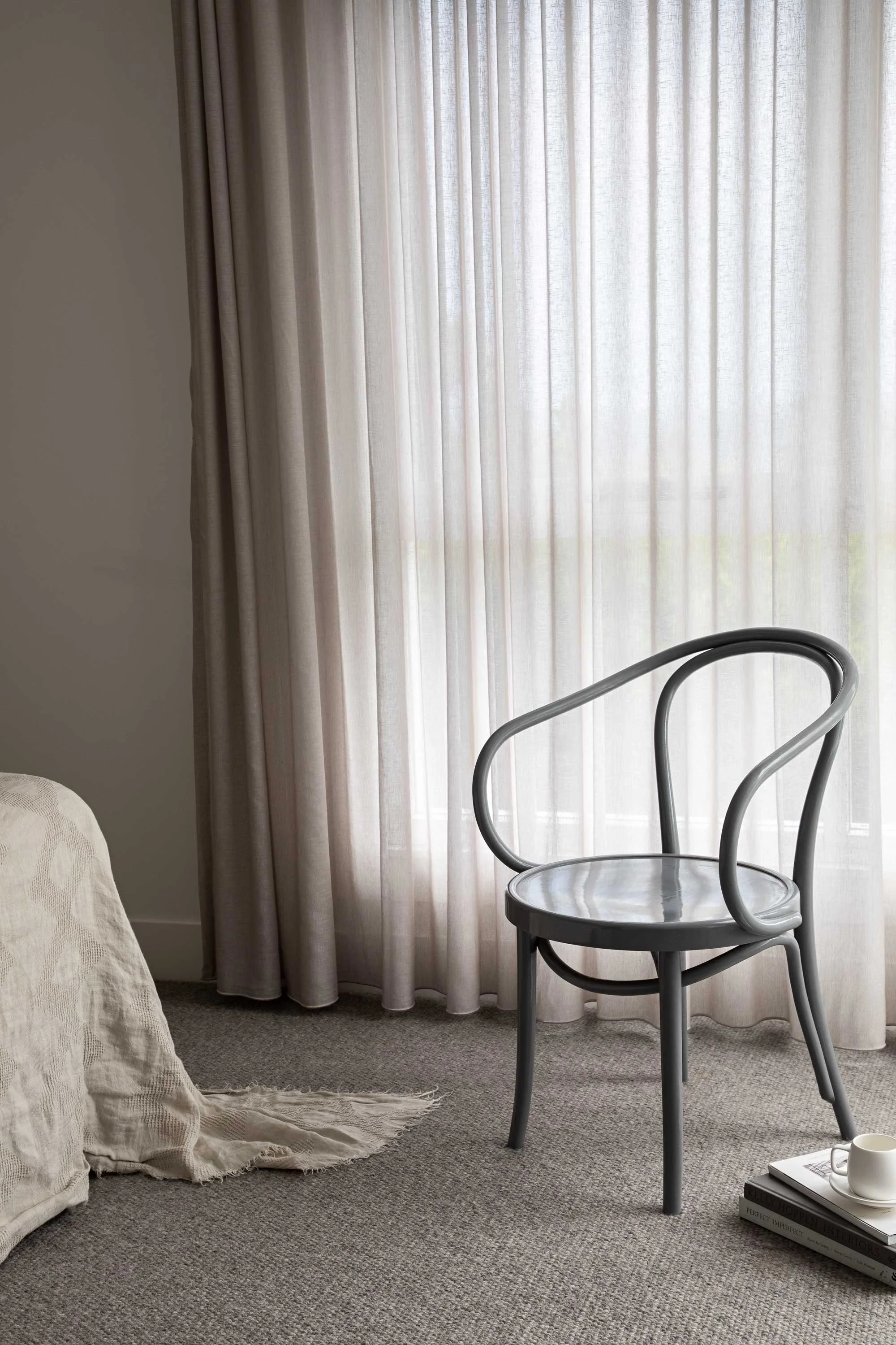 Bedroom chair near window with see through curtains NSW South Coast