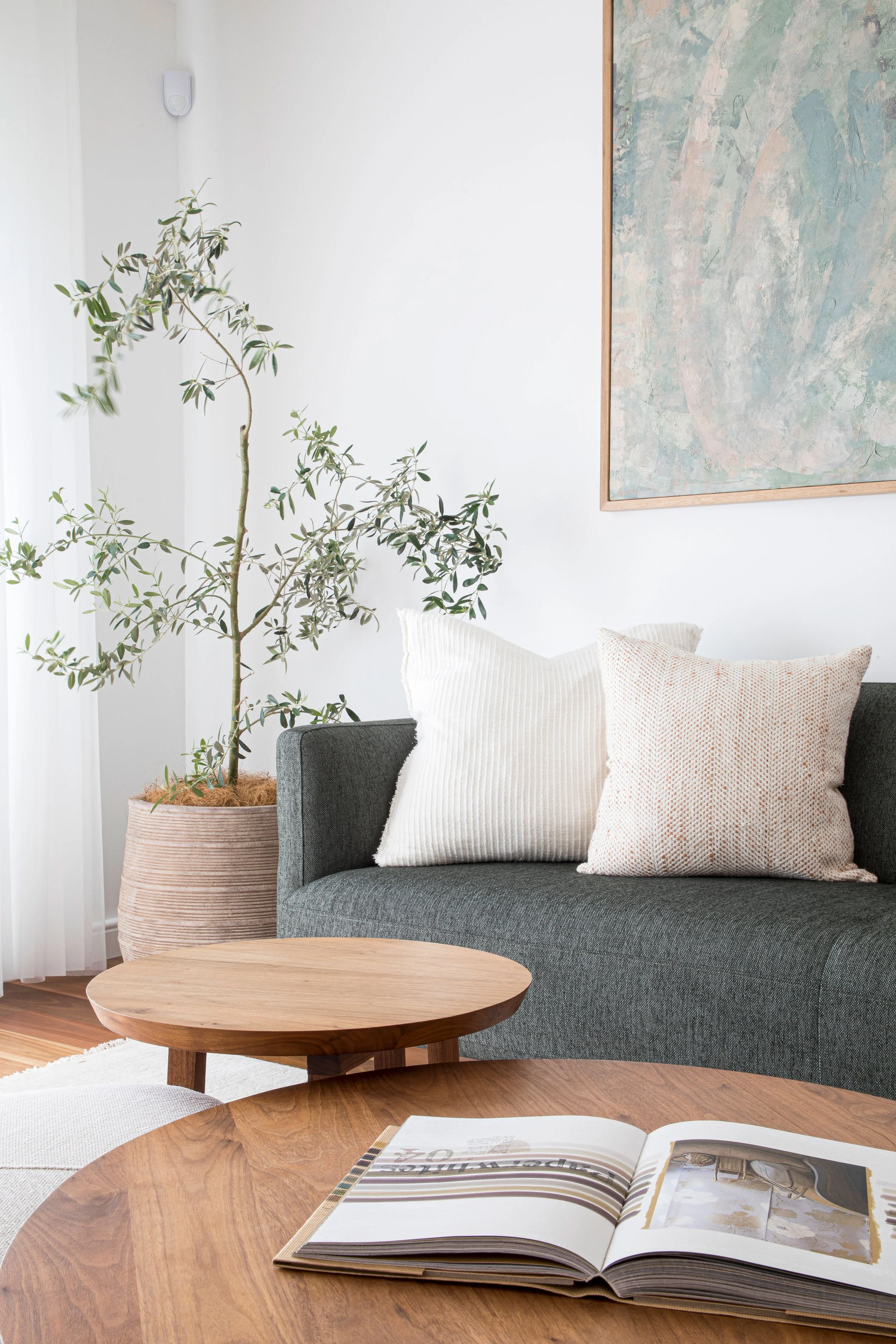 Sydney living room design wooden coffee tables Dark lounge white walls artwork