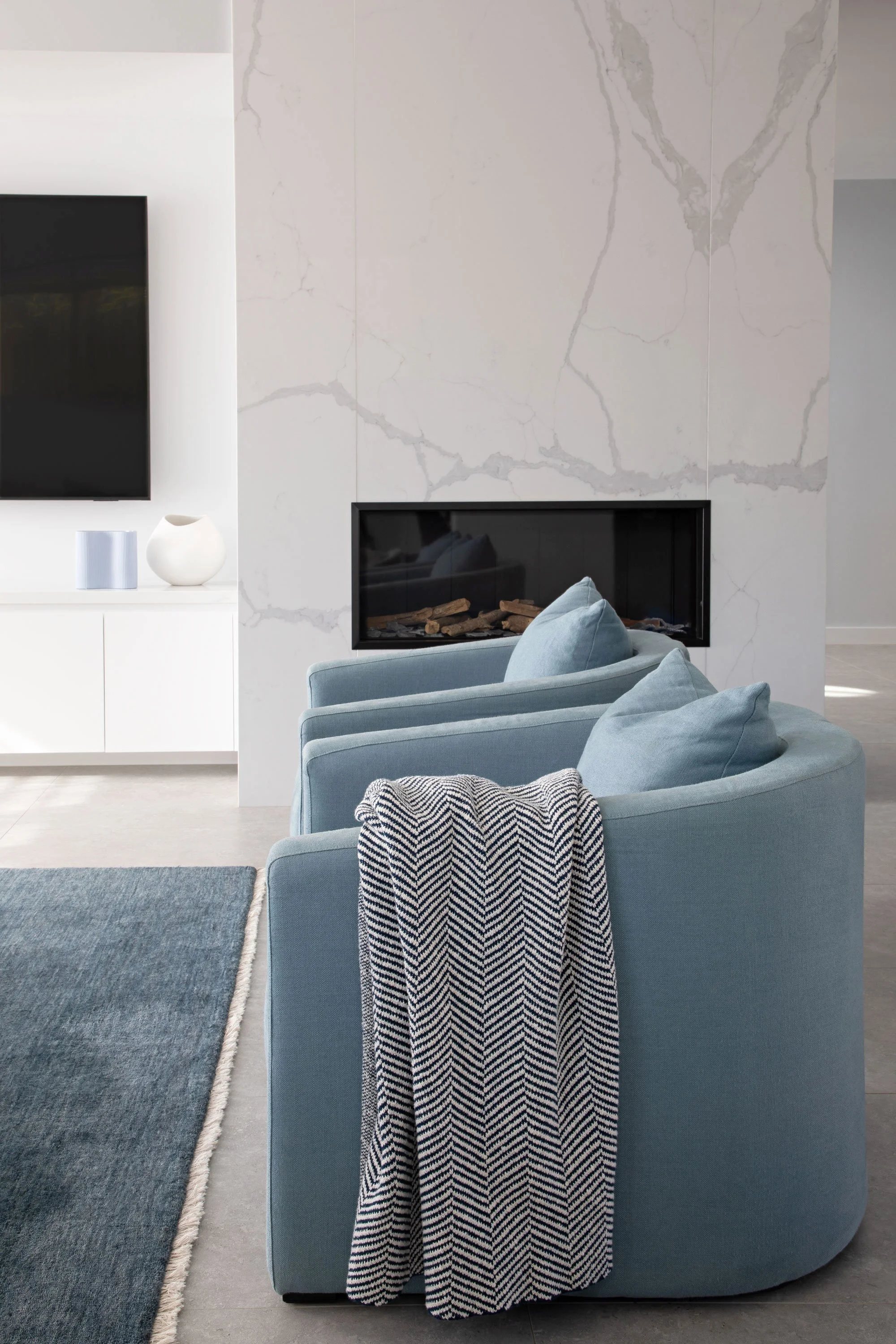 Modern living room chairs with fireplace and wall television Sydney