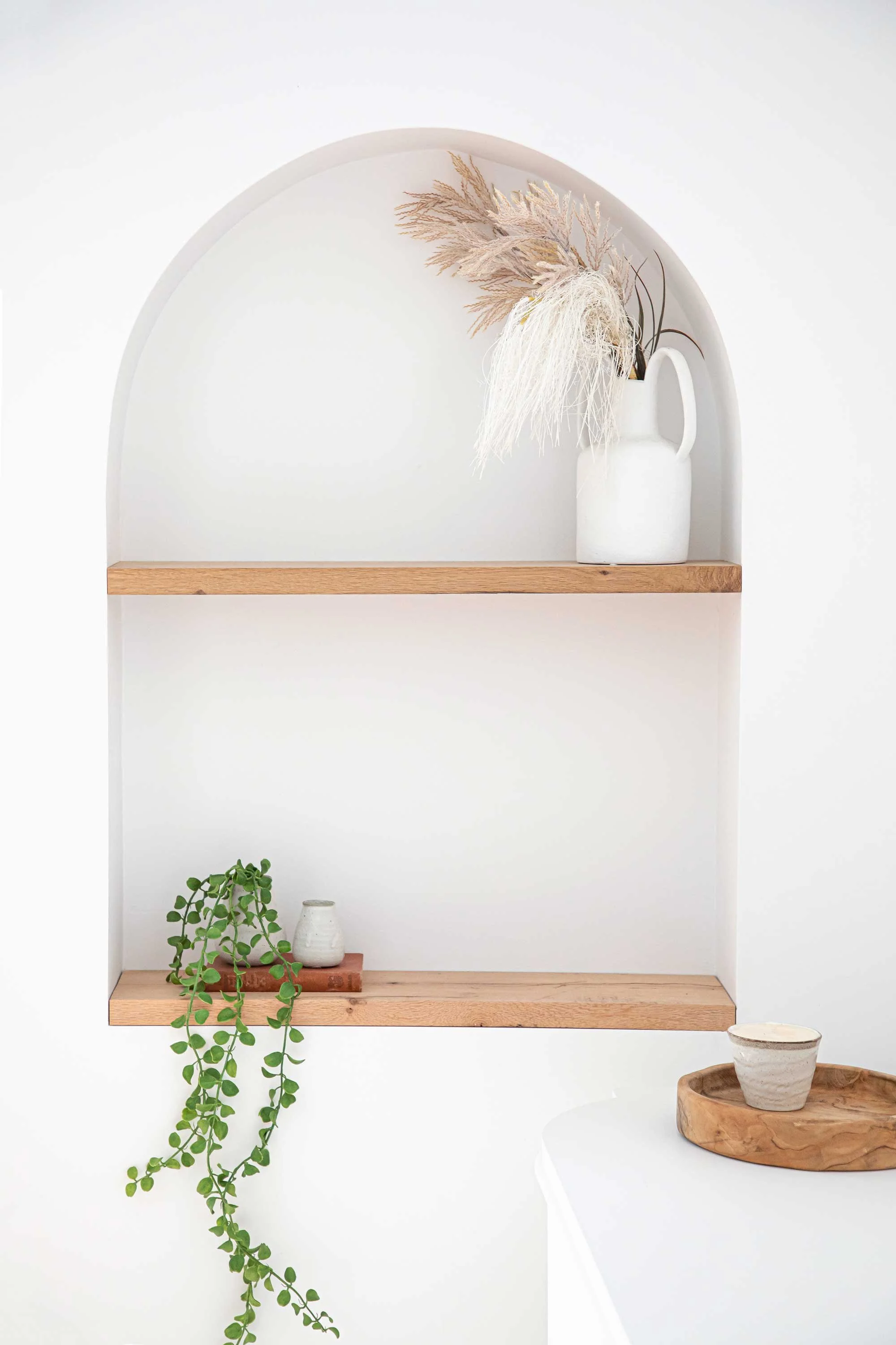 White recessed arched shelf nook wooden shelves hanging plant Sydney