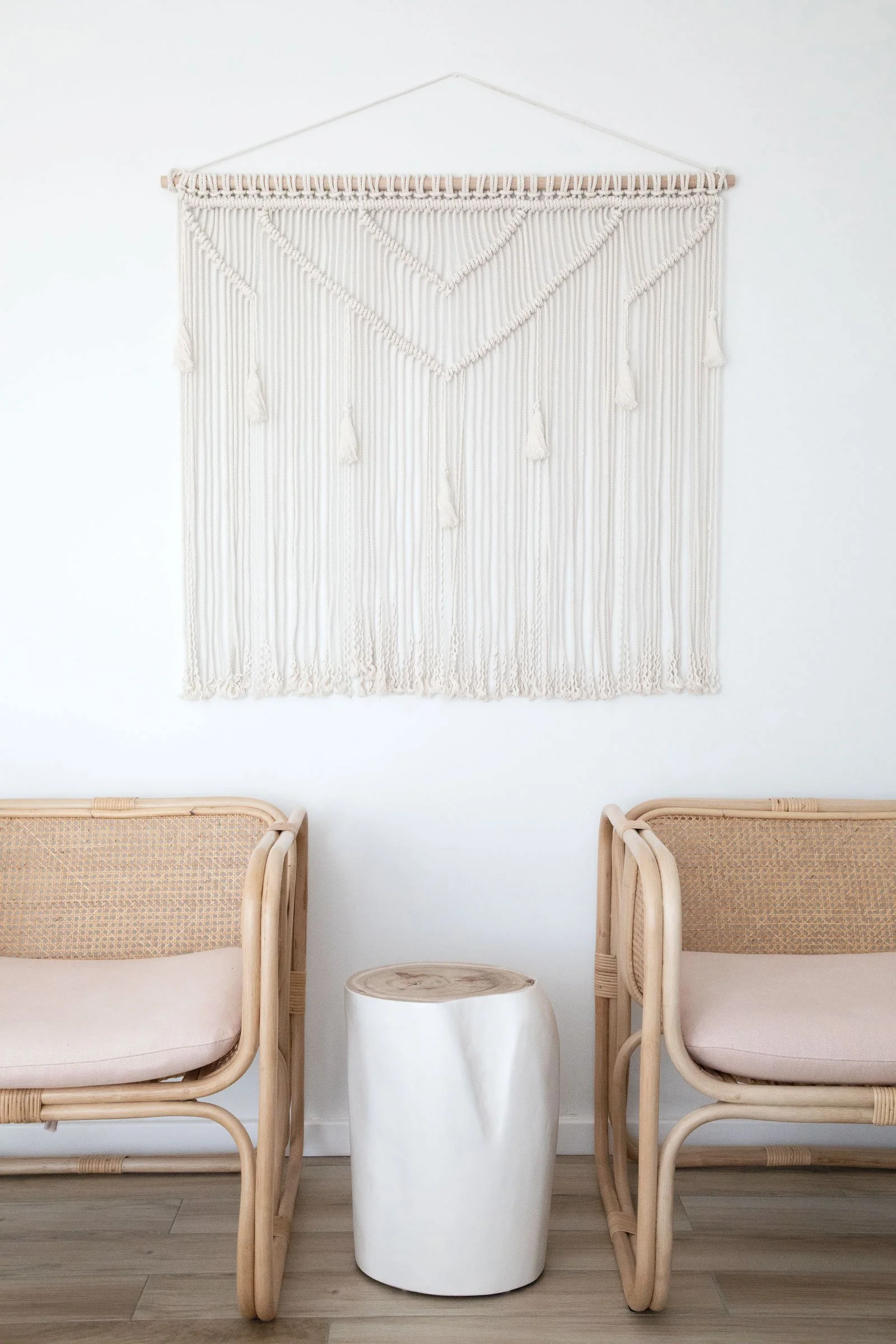 NSW South Coast styled living area cane chairs wall hanging white wood side table