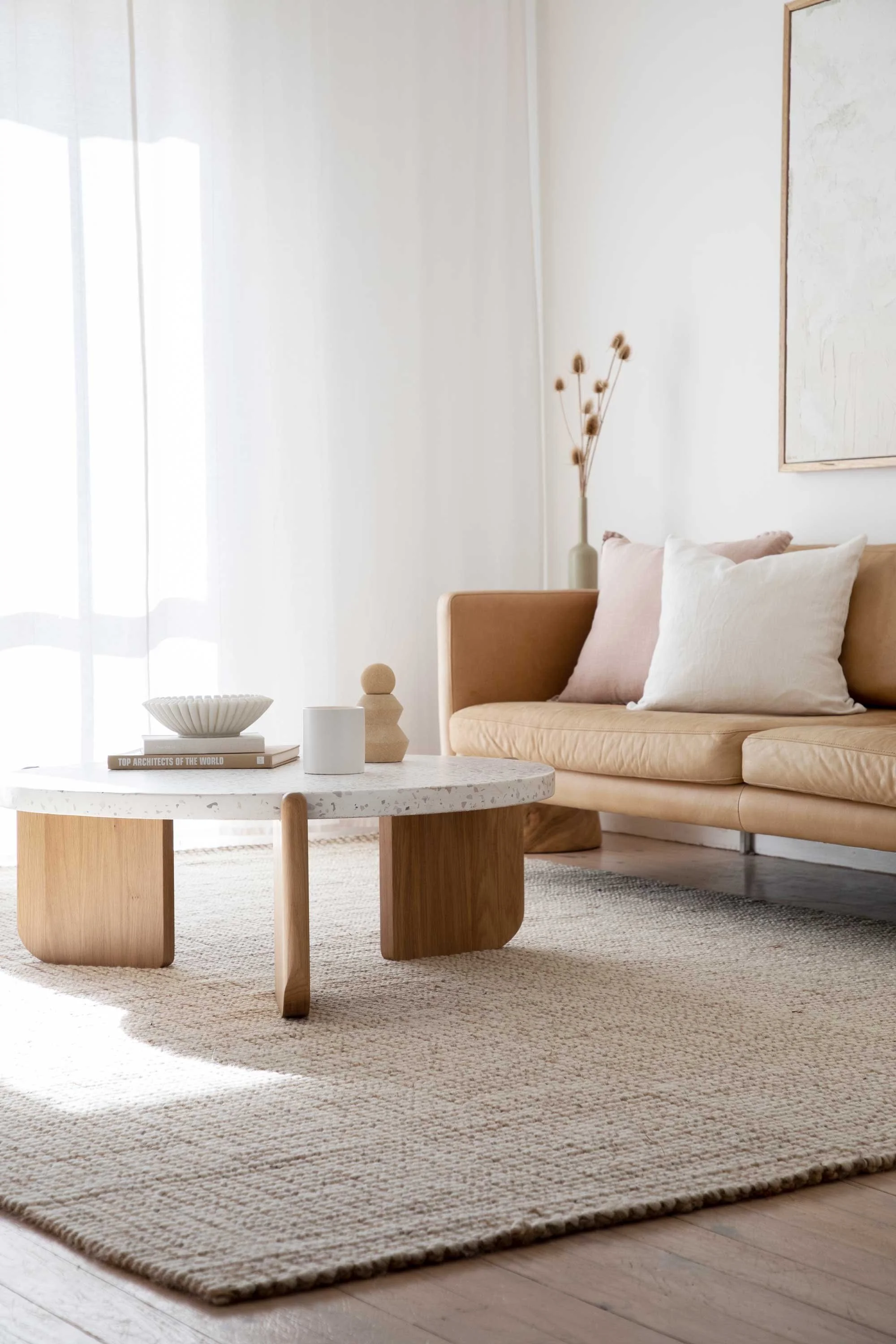 Modern light living space Sydney white curtains round designer coffee table lounge