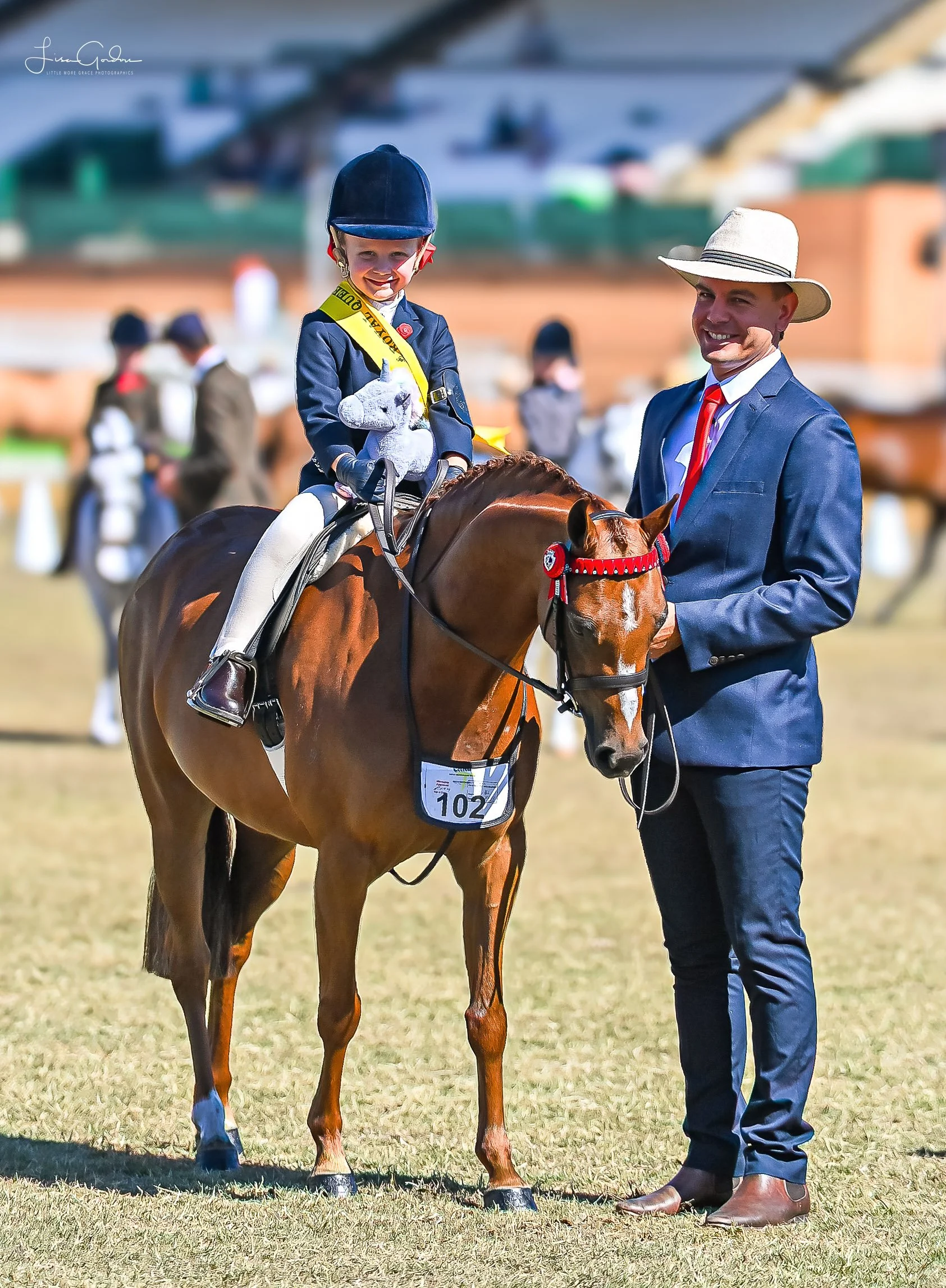 CoatSheda family with a horse at an equestrian event