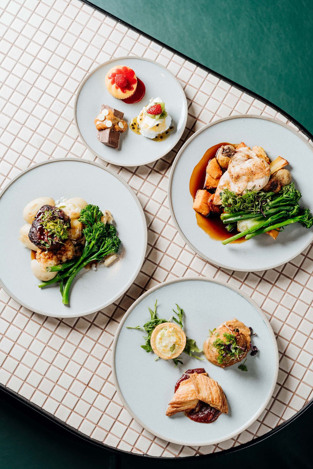 a selection of meals on a mosaic table.