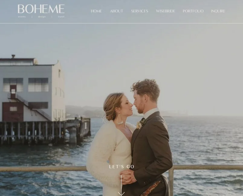 A bride and groom standing close together by the water at sunset, gazing into each other's eyes on a pier.