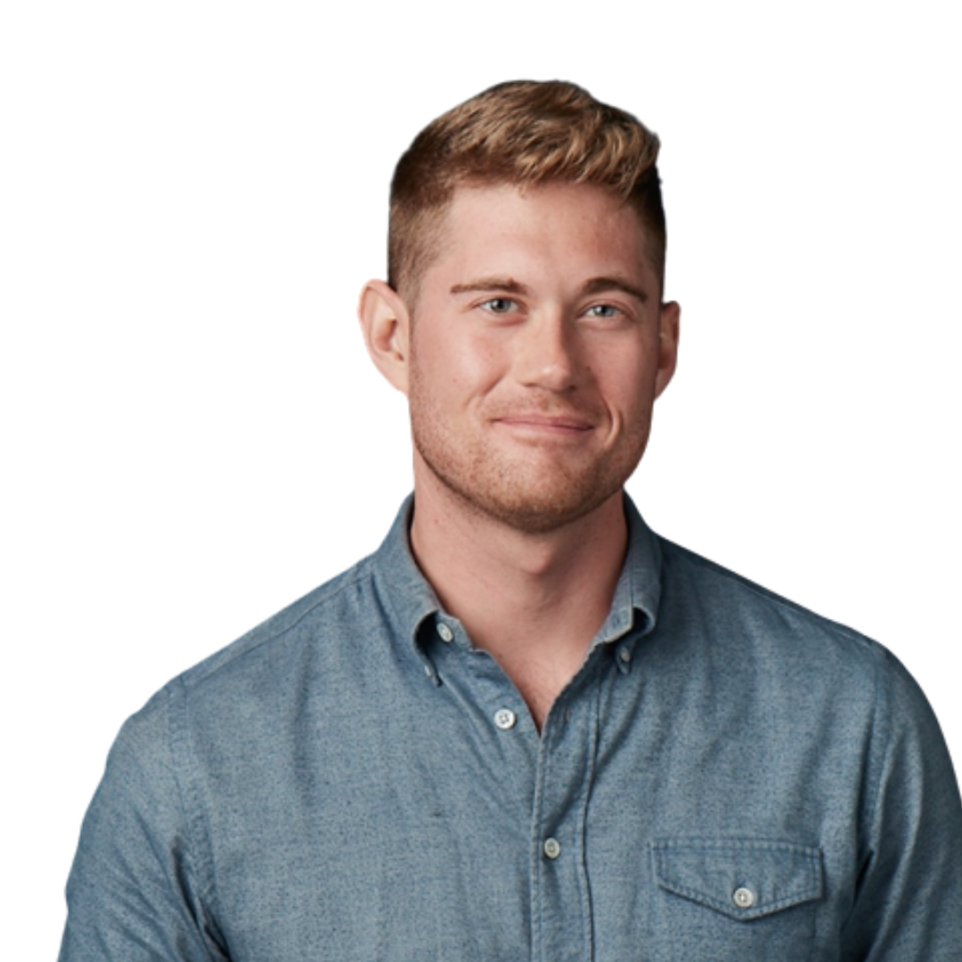 Close-up of Mike McCormick with short, light brown hair, wearing a button-up denim shirt, looking at the camera with a slight smile
