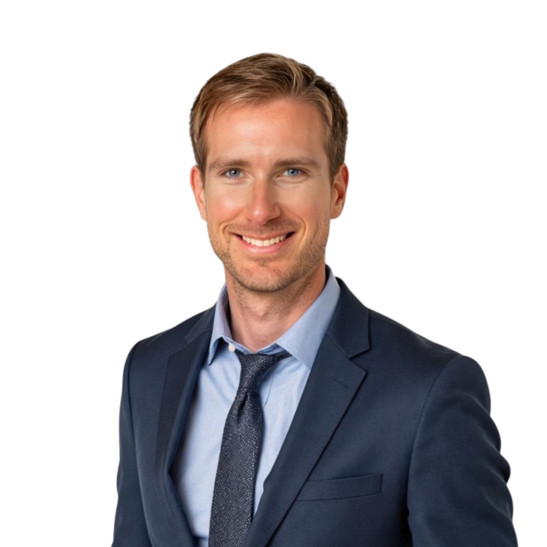 Portrait of Max Henderson smiling man in a navy suit, light blue shirt, and dark tie against a white background.