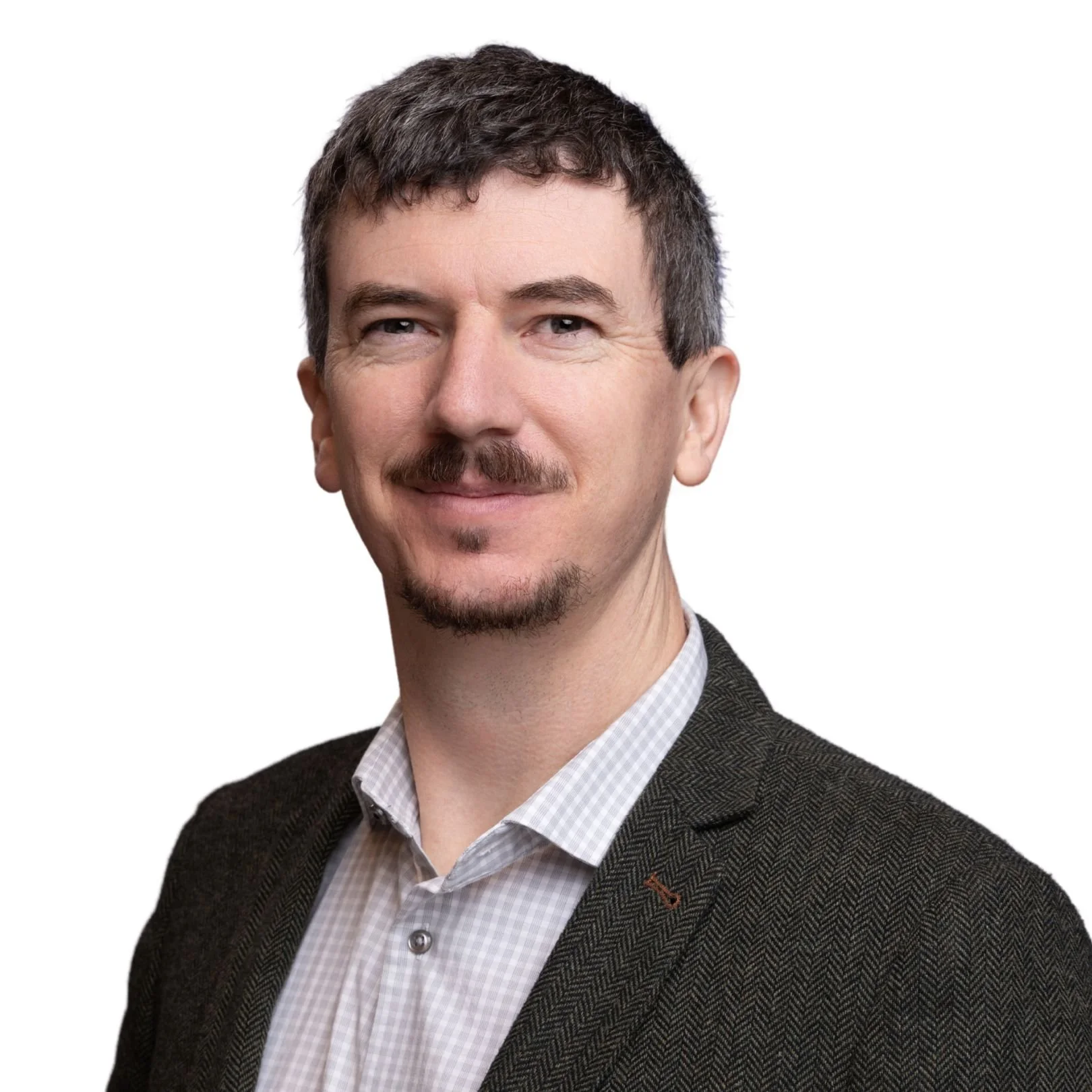 A headshot of Sean McGregor with short dark hair, a mustache, and a goatee, wearing a checkered dress shirt and a dark blazer.