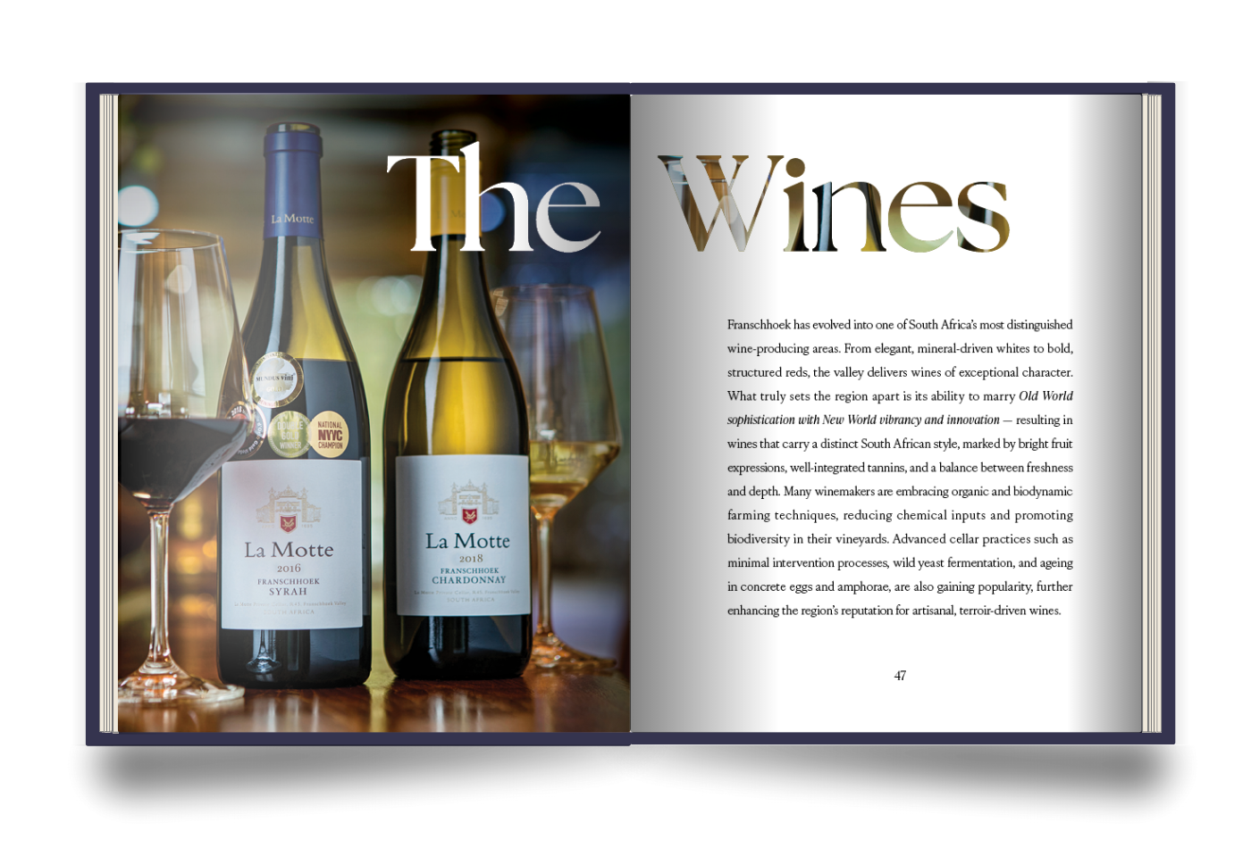 The Franschhoek Experience Book with a spread titled 'The Wines' with a photo of La Motte wines on the left page, and text on the right page about Franschhoek, South Africa's wines.