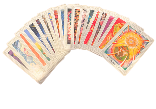 A deck of tarot cards fanned out, showing detailed colorful illustrations, with one card prominently displaying a radiant sun and a figure in front of it.