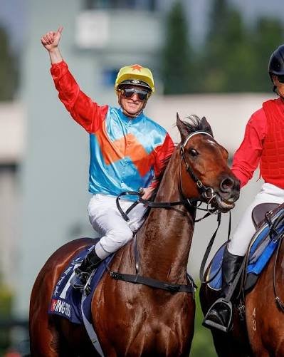 Ka Ying Rising celebrating post‑race with his jockey giving a thumbs‑up, capturing the energy and colour of a Hong Kong feature‑race victory moment.