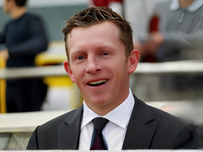 Matt Laurie standing outdoors in a dark suit and tie, photographed in a professional setting suitable for a trainer profile on Signature Pedigrees.