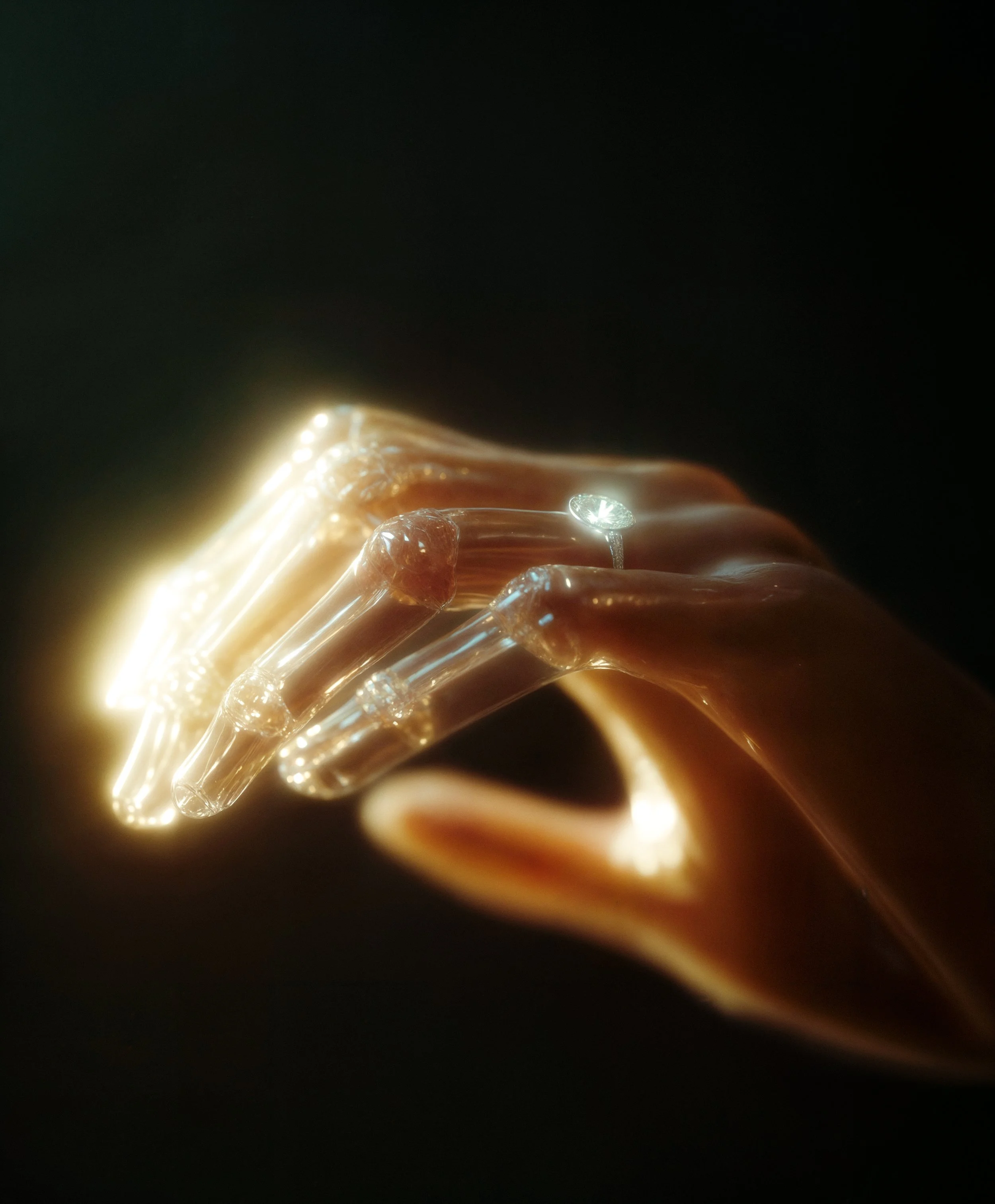 A close-up of a transparent, illuminated robotic hand with visible joints and a shiny ring on its finger, set against a dark background.