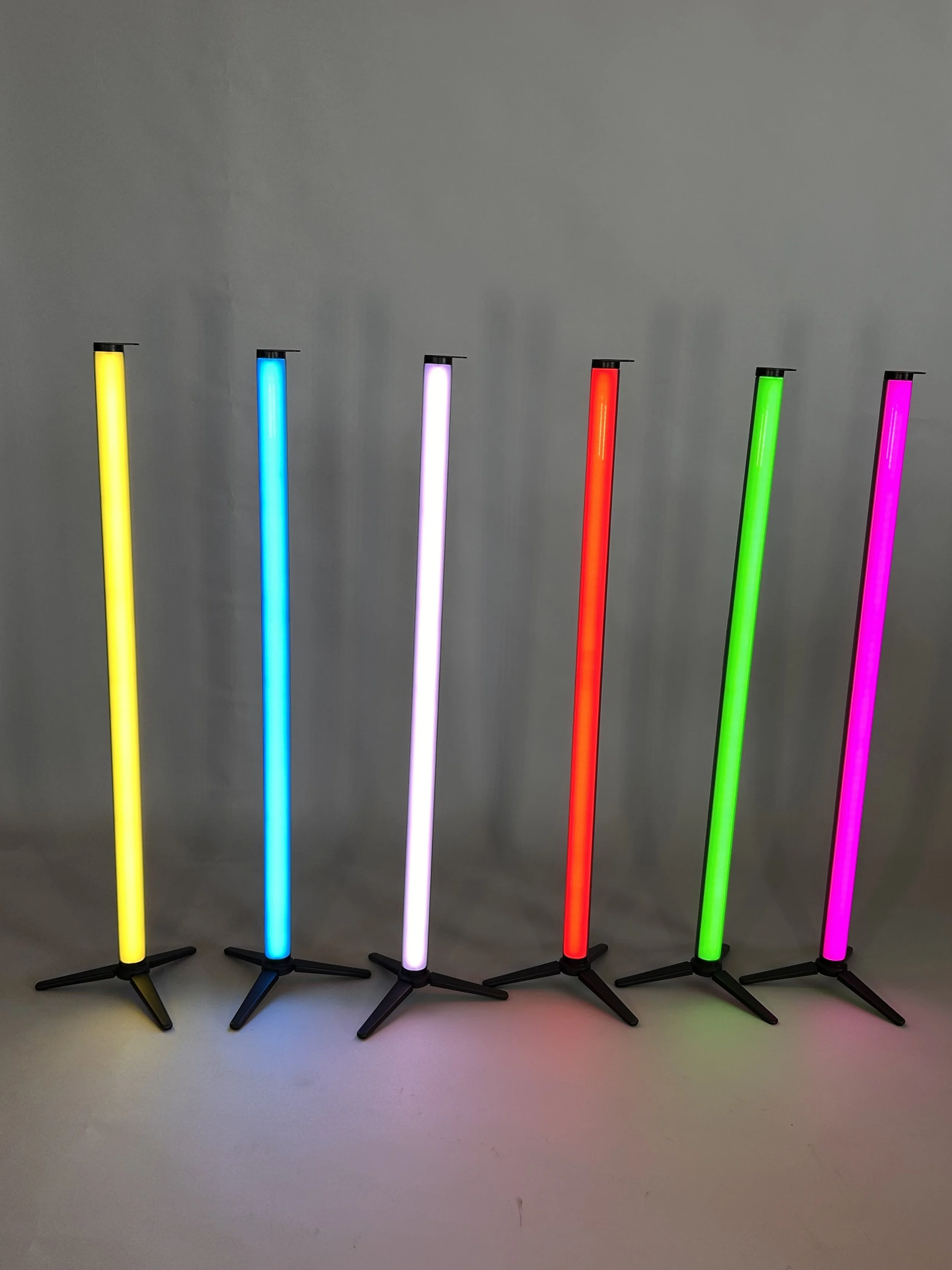 Six floor-standing LED lamps in yellow, blue, white, red, green, and pink colors, arranged in a row against a gray background.