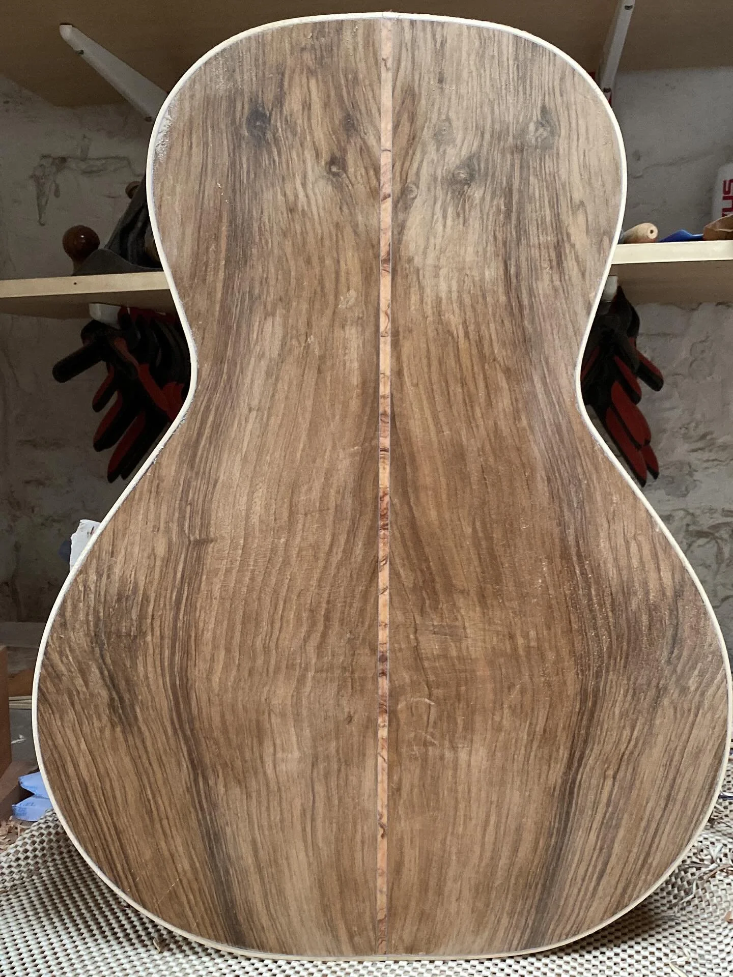 Getting the binding glued does something to the silhouette of the guitar. Great to finally see the new models soundbox complete. That walnut with holly binding is a particularly beautiful combo.