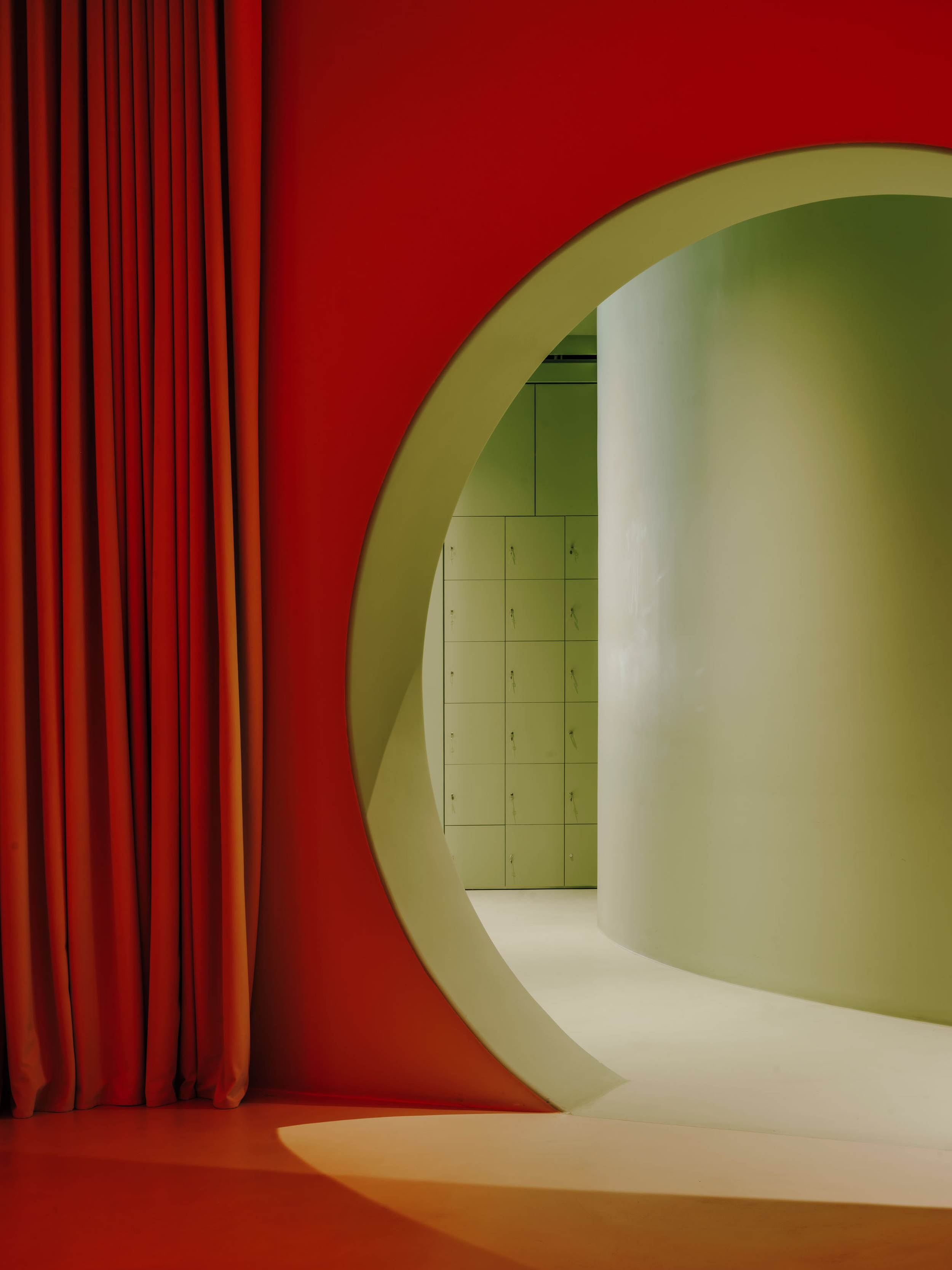 Circl Pilates studio in Barcelona, red curtain and arched entrance designed by Isern Serra