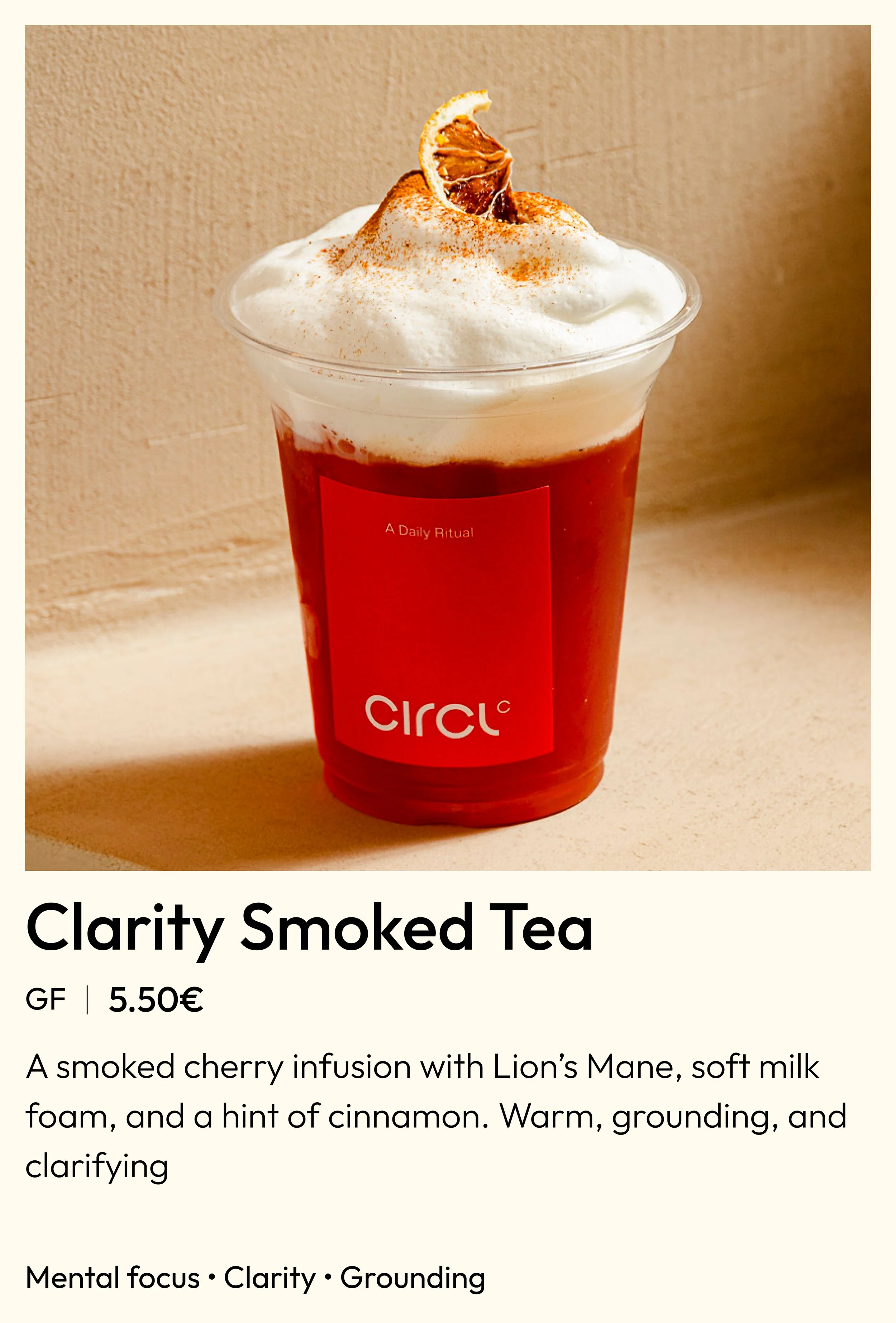 A clear plastic cup filled with a deep red smoked cherry infusion tea topped with whipped milk foam, cinnamon, and a dried citrus slice, with a red label that reads "Circ" and a small text that says "A Daily Ritual."