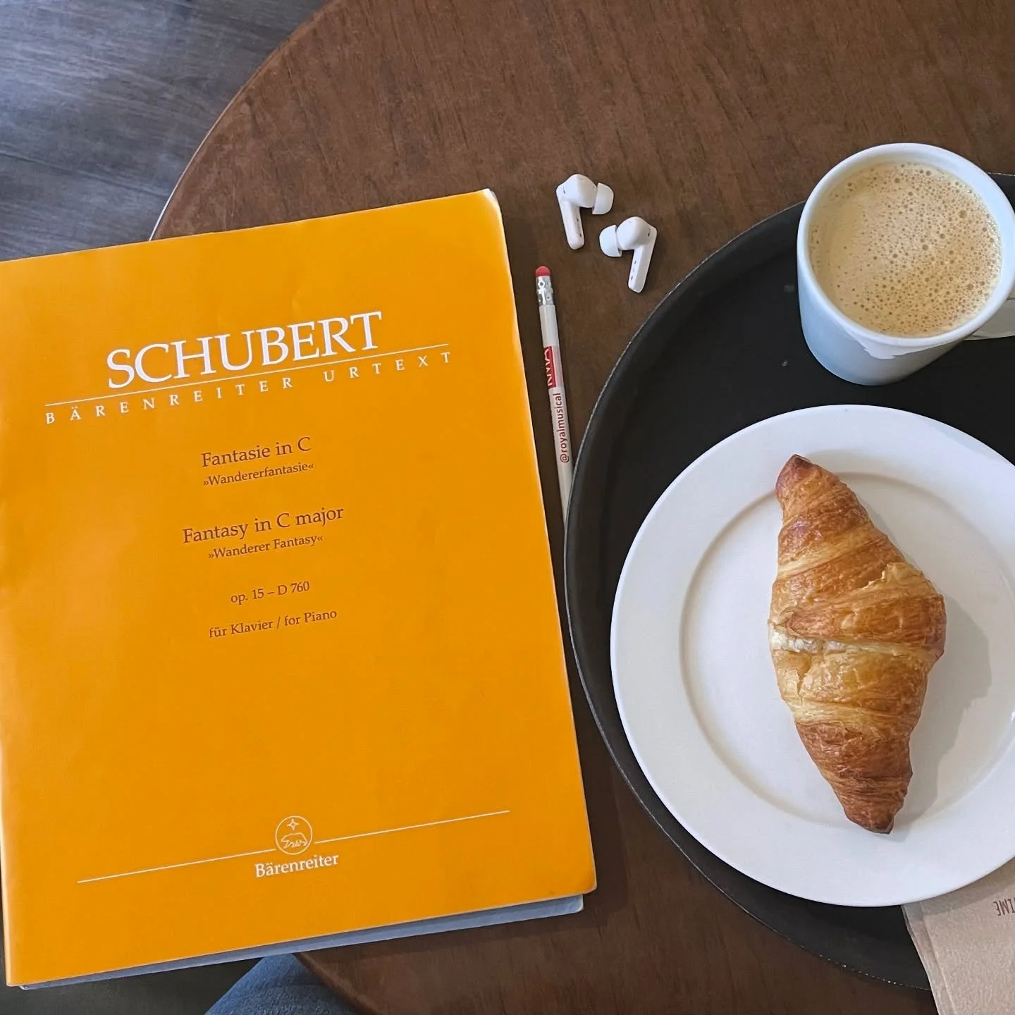 Sitting at a coffee shop after playing a run-through of my entire repertoire for next week&rsquo;s recital ☕️🥐 I am listening to myself play through it all while following the score and making further annotations. I now have tons of new things to th