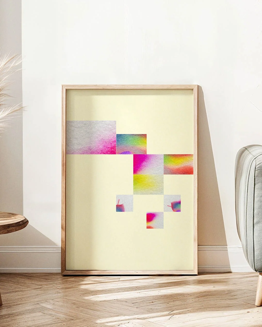 Framed abstract art print featuring a light yellow background and a diagonal arrangement of eight small, colorful watercolor-style squares.