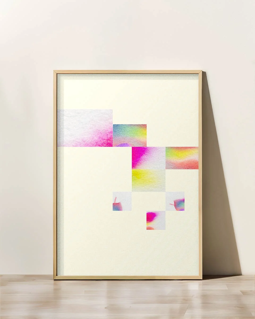 Framed abstract art print featuring a light yellow background and a diagonal arrangement of eight small, colorful watercolor-style squares.