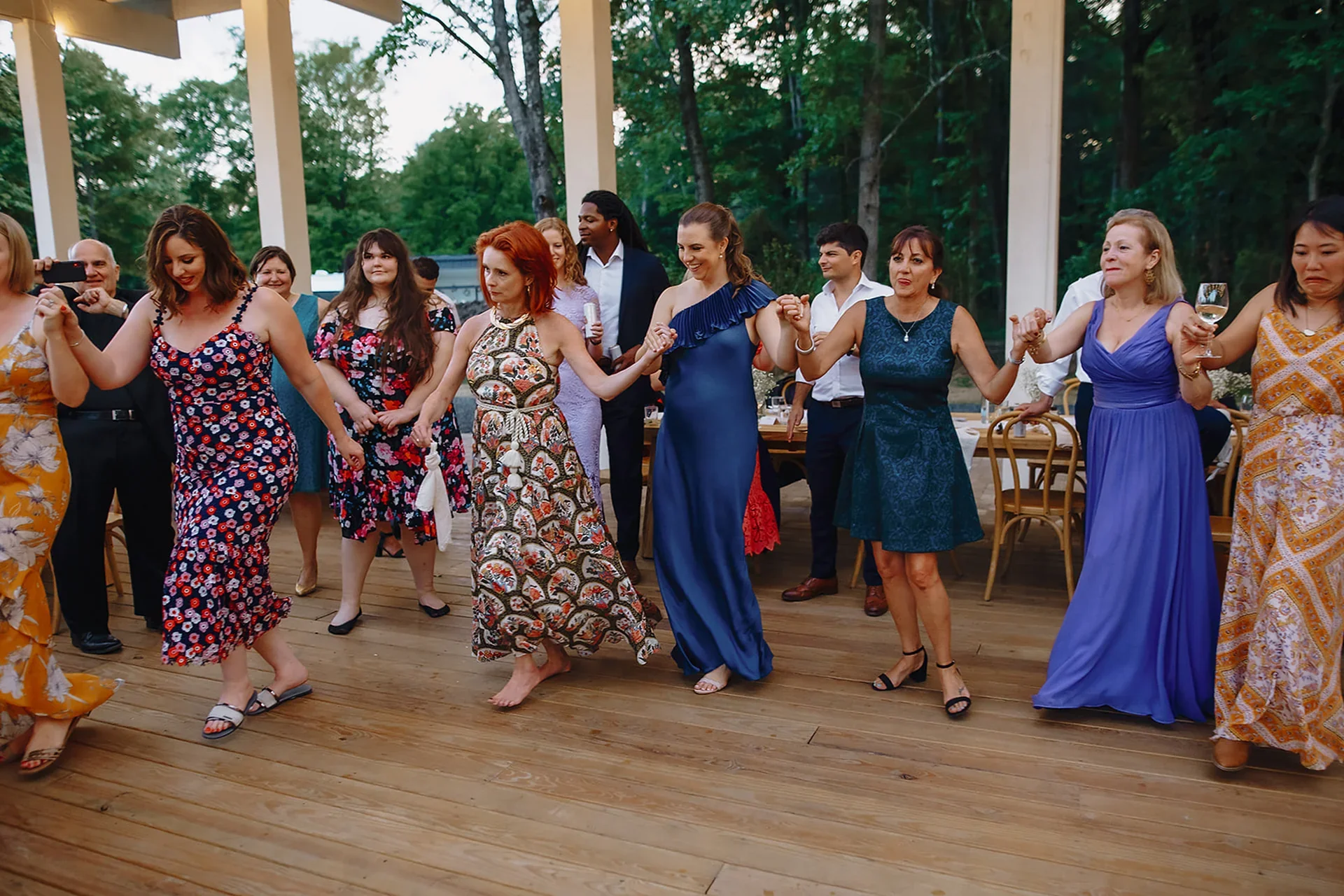 Guests dancing during a summer wedding at Old Mill Inn in Wallkill, NY with Aria Melody, the best multicultural wedding DJ in NYC, creating an upbeat outdoor celebration