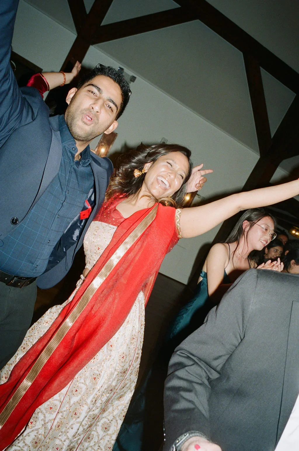 Joyful candid moment of guests dancing during an Indian wedding reception at Crossed Keys Estate in New Jersey, celebrating with the best Indian wedding DJ in NJ — Aria Melody DJ.