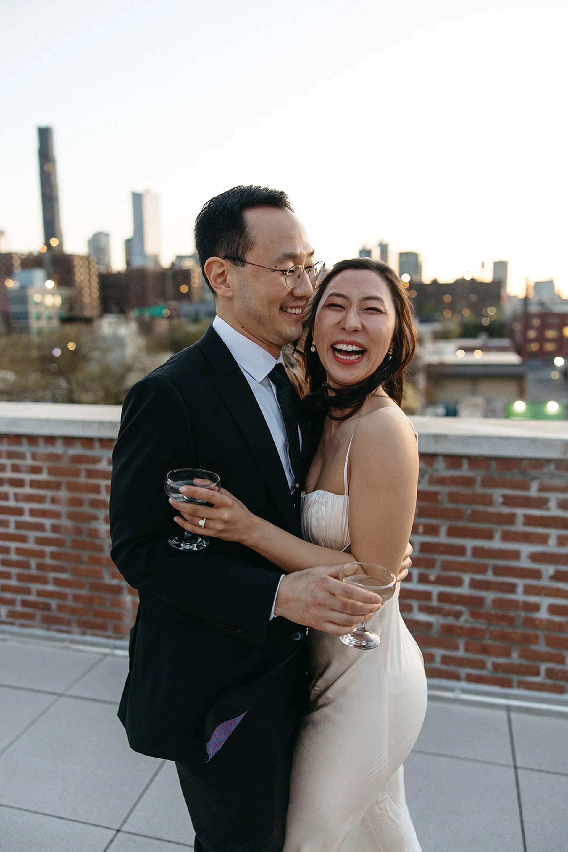 Romantic Manhattan rooftop wedding moment captured at sunset with Aria Melody, the best New York wedding DJ, curating the soundtrack live.