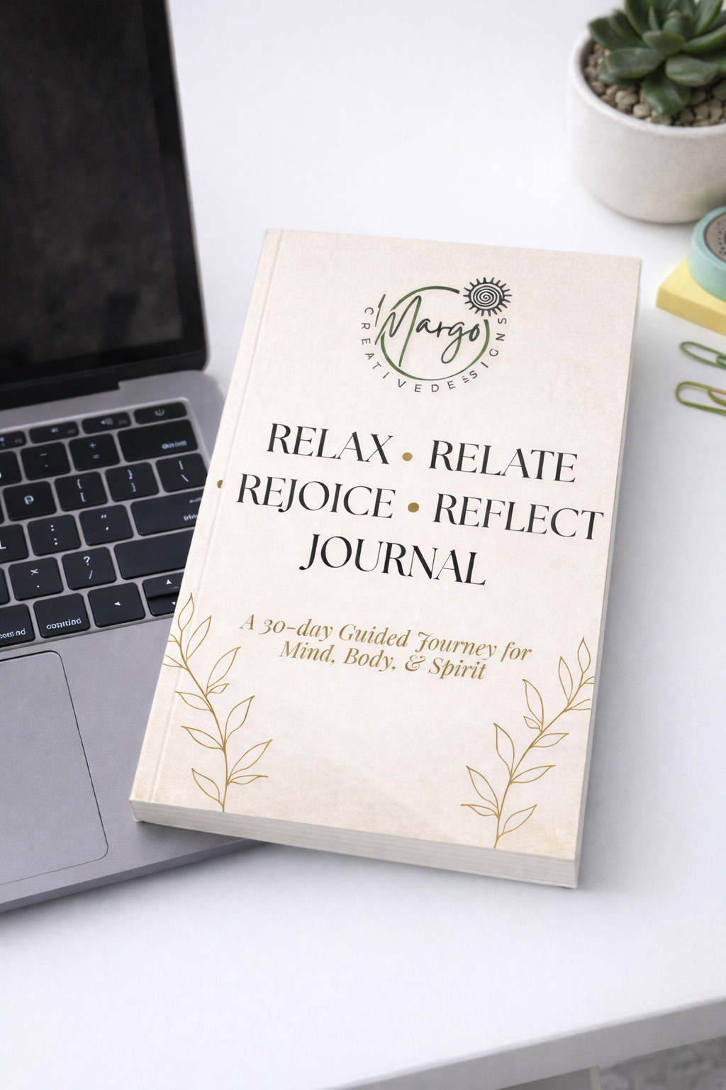 Guided journal with MacBook and plant.png